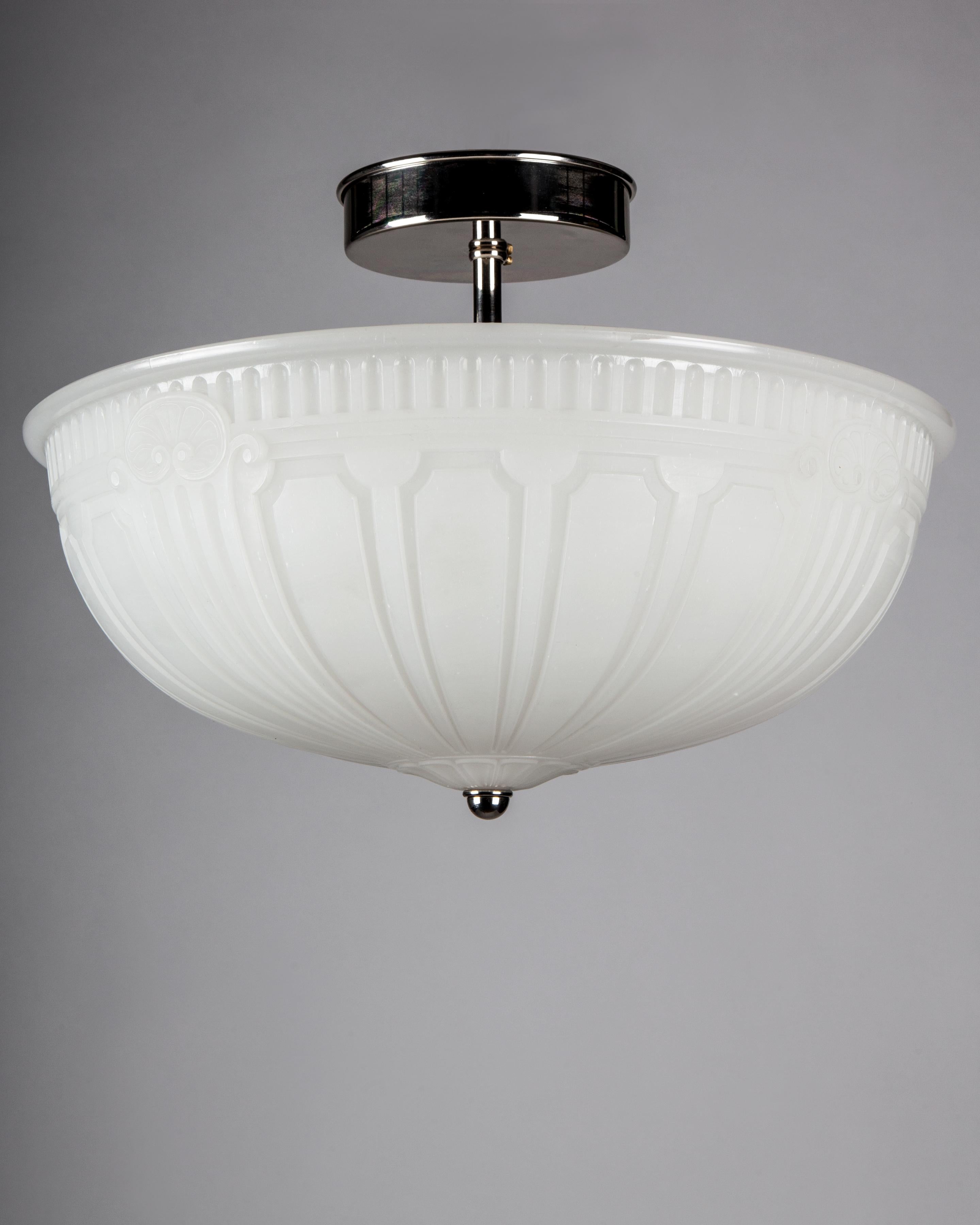 AHL4122

An antique 1920s cast opaline glass semi-flush mount with a faceted top border and a tapered panel dome bottom on polished nickel fittings made in the Remains Lighting workshop. Due to the antique nature of this fixture, there may be some