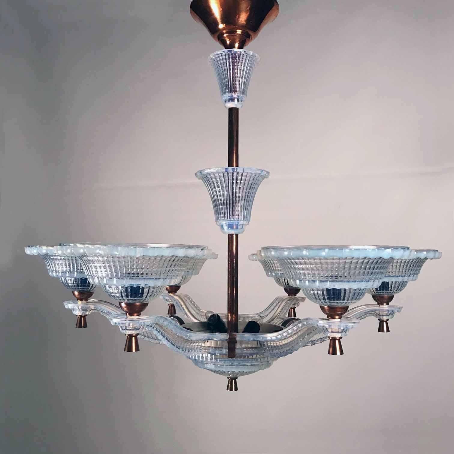 A period Art Deco opalescent glass and copper chandelier signed Ezan. This chandelier has six arms that extend from a central stem. All visible parts are decorated with Art Deco opalescent glass and copper detailed elements.