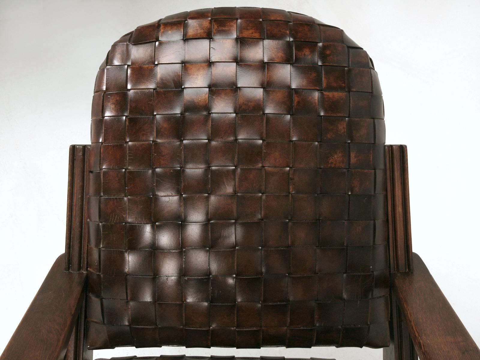 Early Art Deco or late Arts & Craft woven leather club chairs are constructed from thick leather straps are vegetable tanned and hand colored with a combination of waxes, proteins and mineral dyes to fully penetrate the leather. A second application