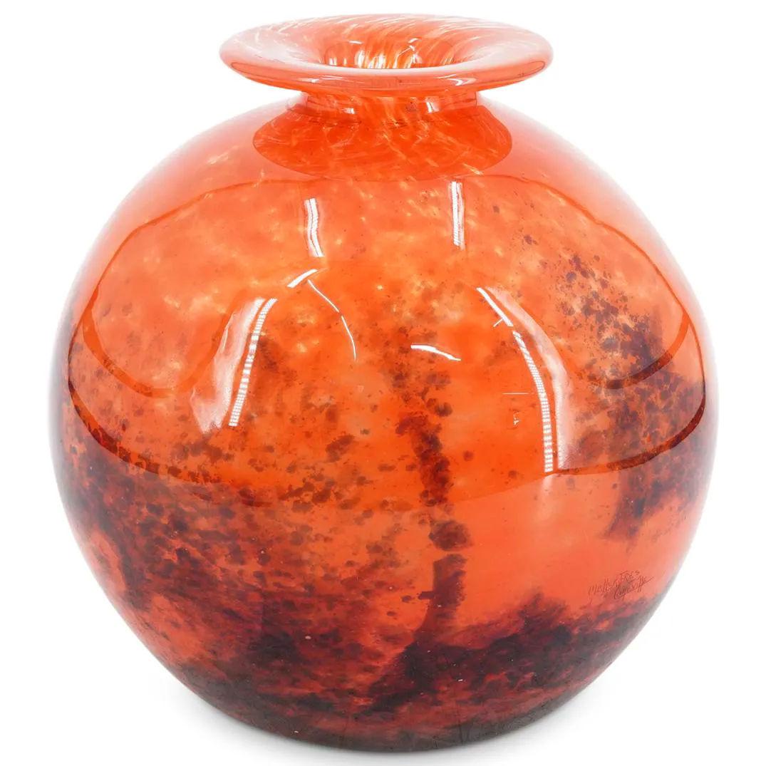 Our Art Deco period glass vase in mottled orange has a spherical shape and measures 10 inches tall and 10 1/4 inches in diameter. Acid-etched signature reads MULLER FRES LUNEVILLE. In very good condition.