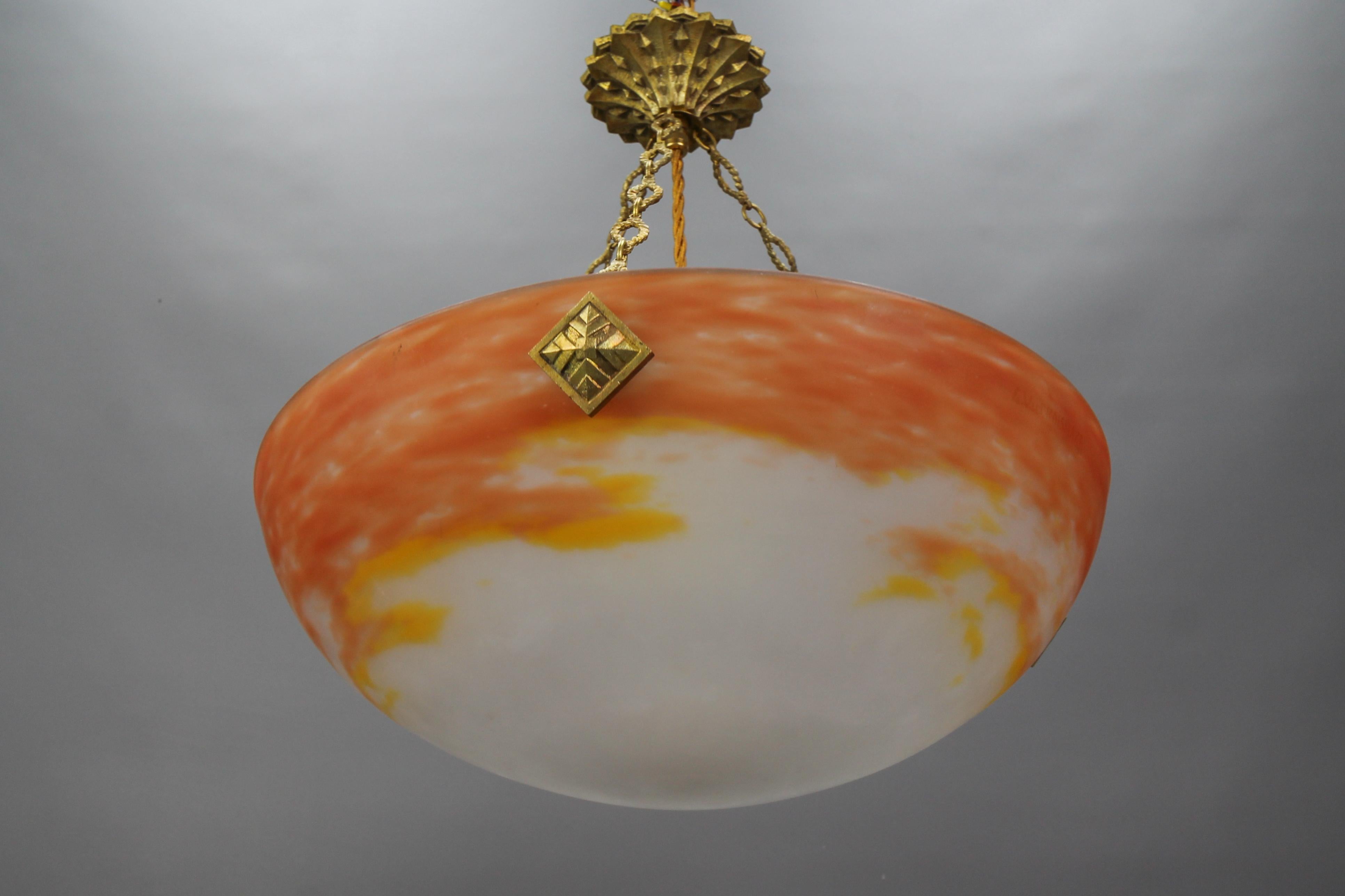 French Art Deco orange and white Pâte de Verre glass and bronze pendant light by G.V. de Croismare, Muller Frères Luneville from the 1920s.
This pendant light is a stunning piece from the French Art Deco period. The bowl is made of orange and white