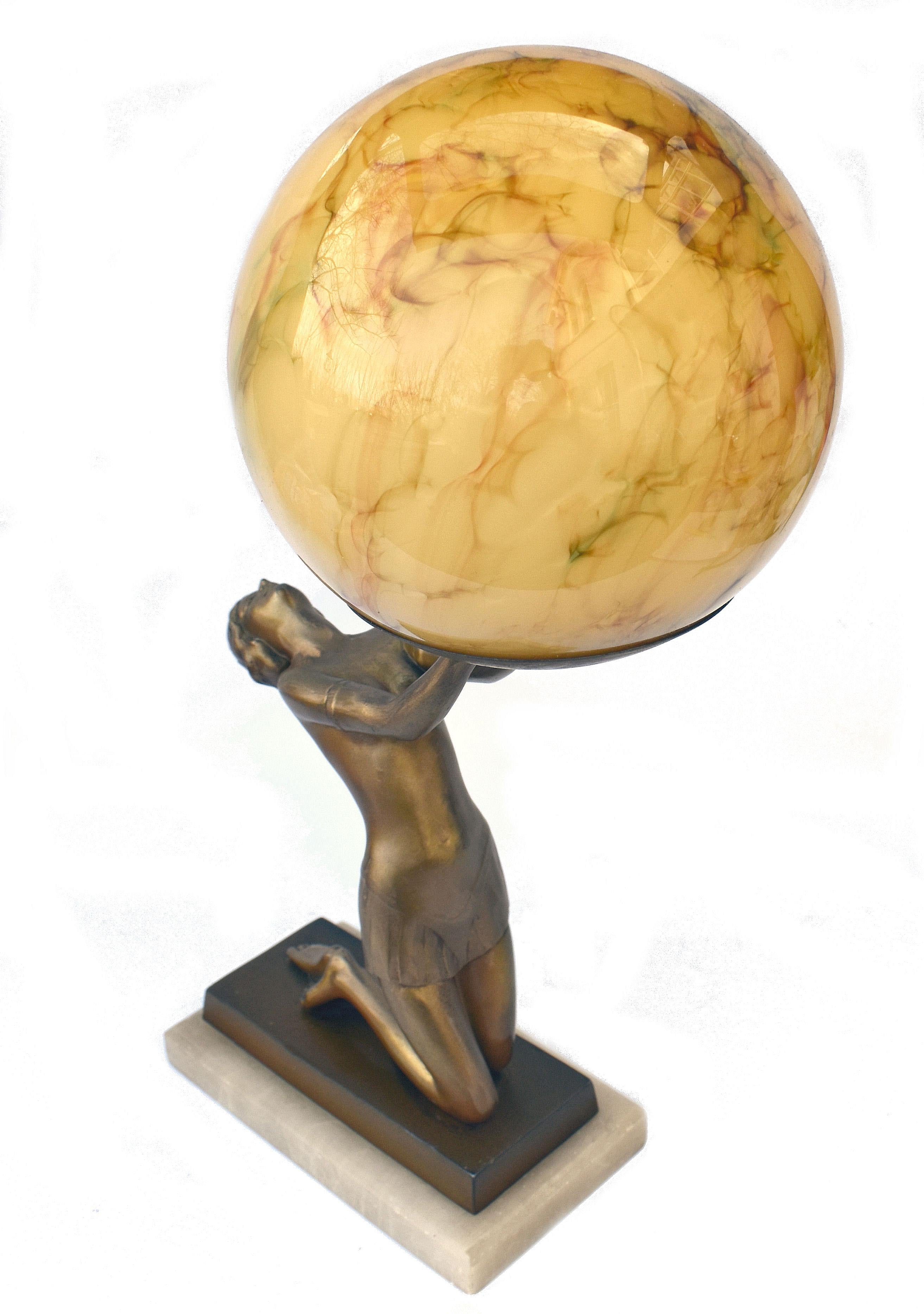An impressive 38 cm tall this original 1930's Art Deco cold painted spelter table lamp features a nude female holding aloft a sepia marble effect glass globe shade. Kneeling on an alabaster & spelter base she is in beautiful condition with very