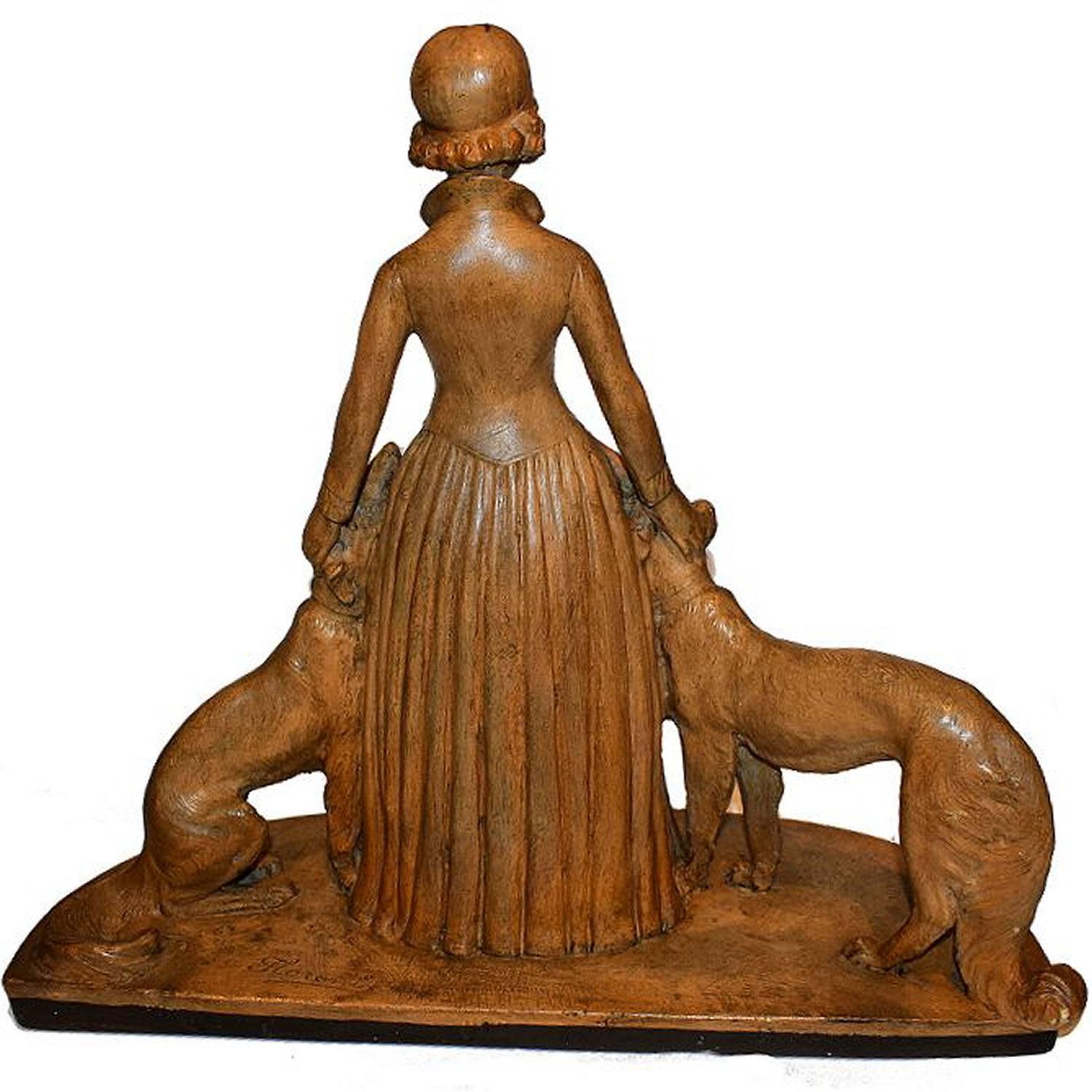 Beautiful Art Deco statue signed by the sculptor FLORENT CF PARIS, which depicts a woman with greyhounds. Wonderful colouring and detailing. She appears to be made from terracotta or some type of ceramic. The condition is excellent, with the most