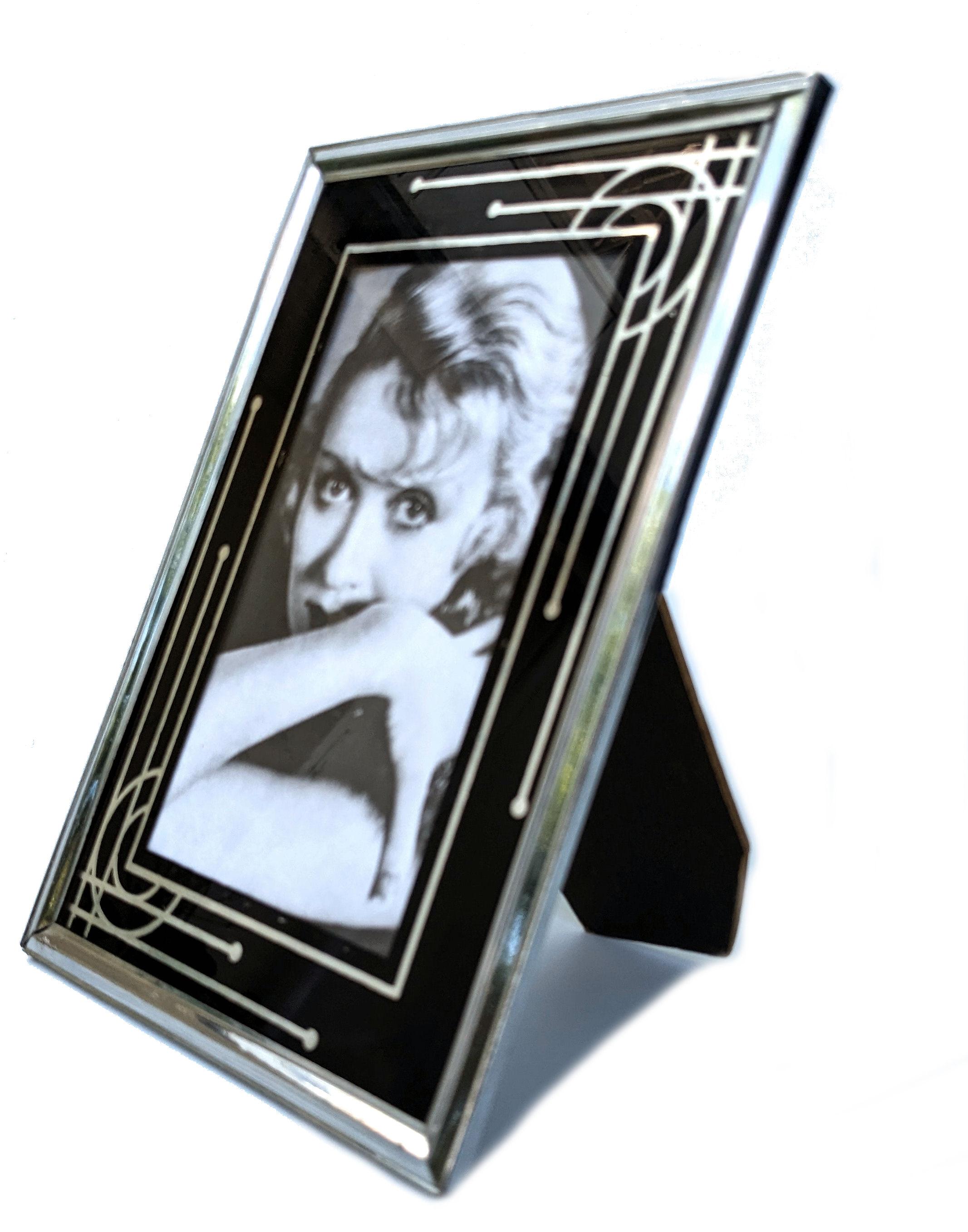 For your consideration is this very stylish original Art Deco free standing picture frame.  The geometric patterning on the glass is reverse painted in black and silver. Very iconic styling, one which can't be mistaken for any other era. The