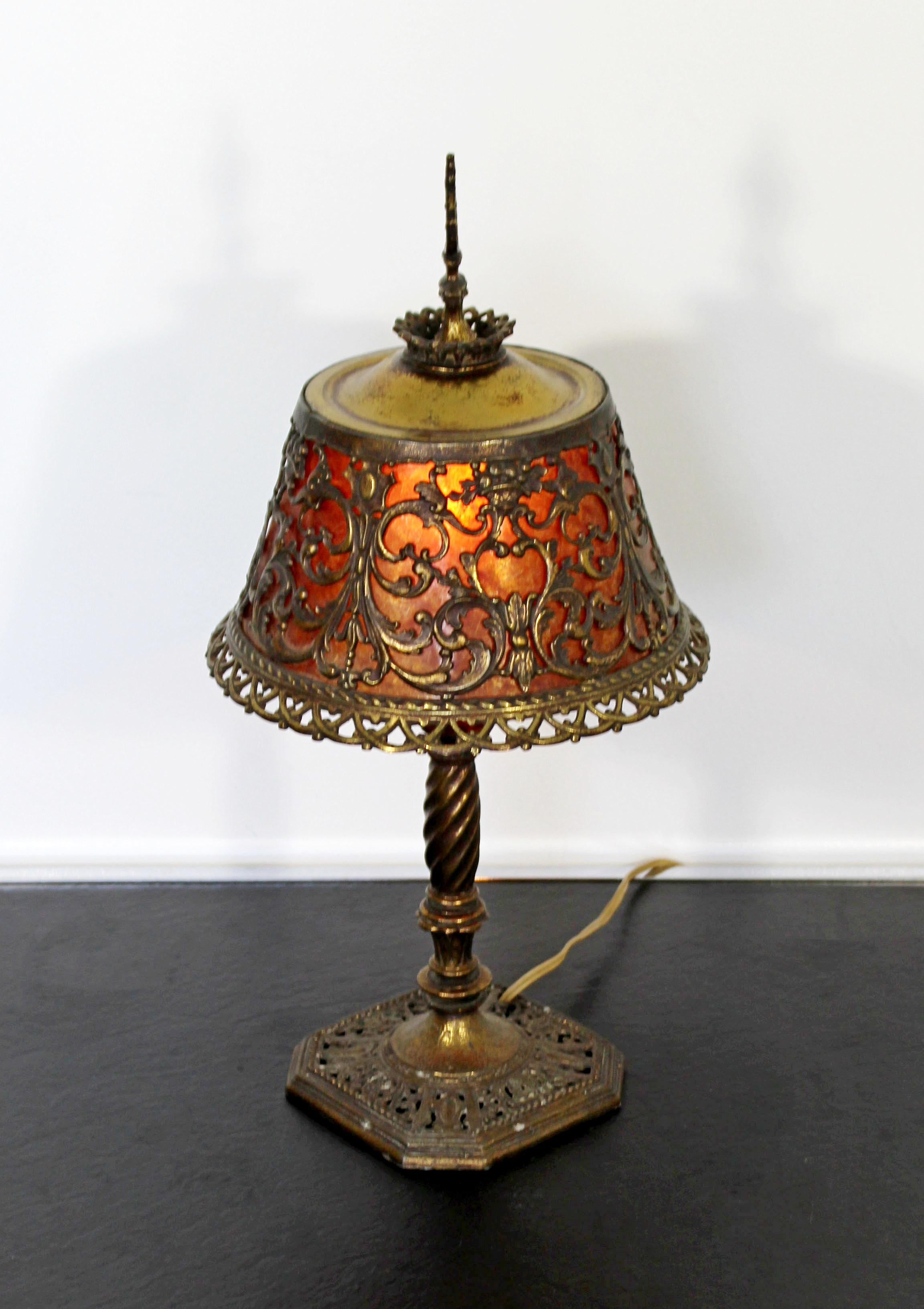 For your consideration is a marvelous and small table lamp, made of ornately detailed bronze and with amber glass that shines when the light is on, by Oscar Bach, circa 1920s. In excellent vintage condition. The perfect patina to the age. The