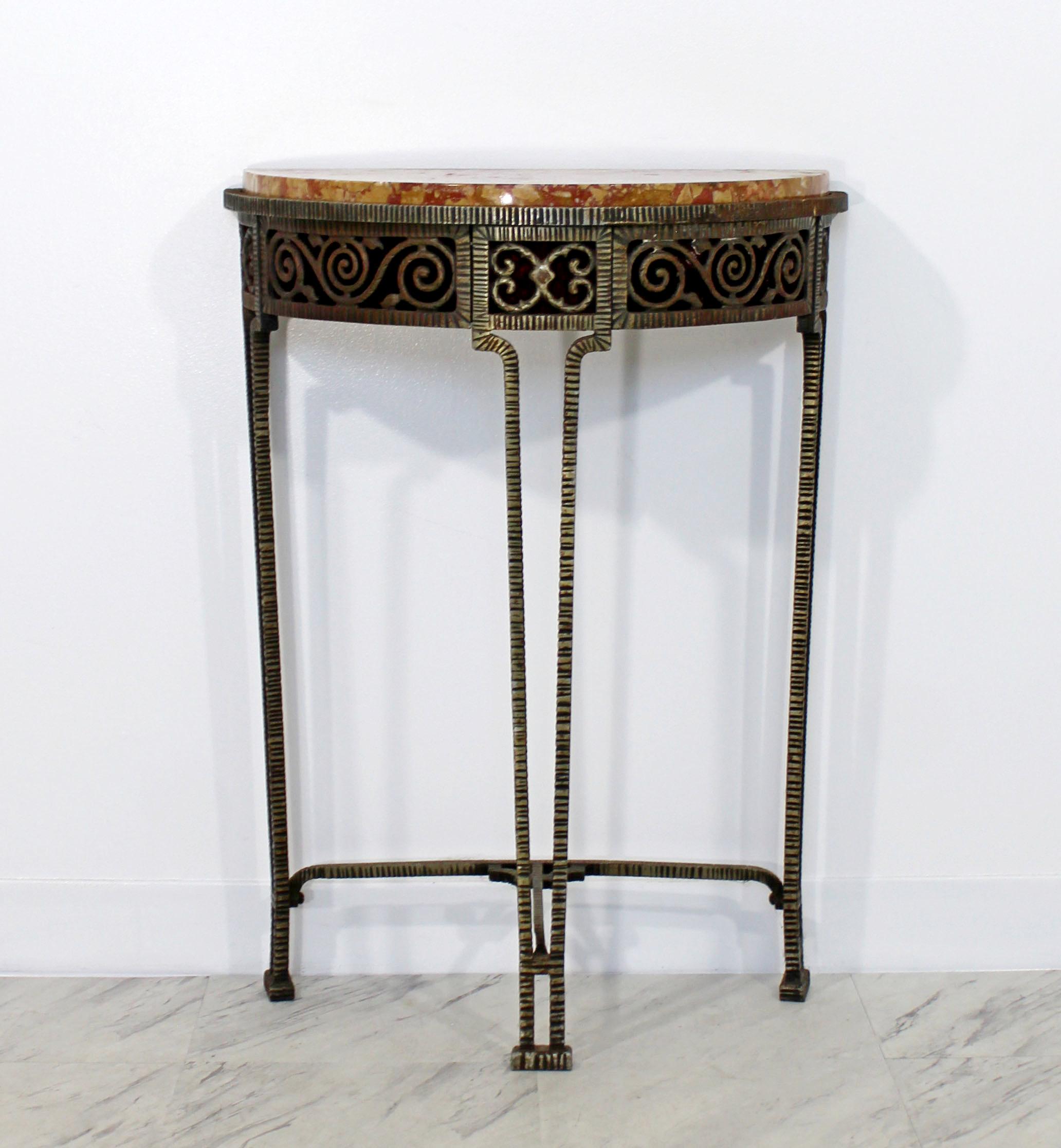 For your consideration is a gorgeous, marble on intricately worked iron, demilune console table, in the style of Oscar Bach. In excellent condition. The dimensions are 22.5