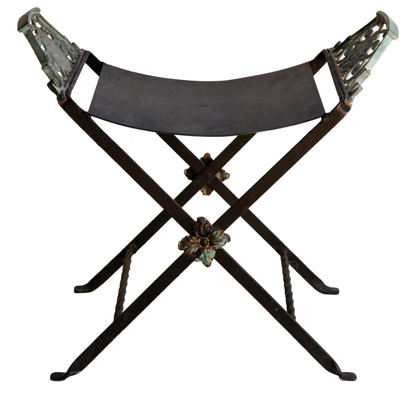 Art Deco period 1920's Oscar Bach Style Iron X Base Vanity Bench features
petal design cast-iron cross bar ornamentation. 
It has great patina, little or no wear to the black seat.
The hand-forged, wrought iron work reflects the style of the
