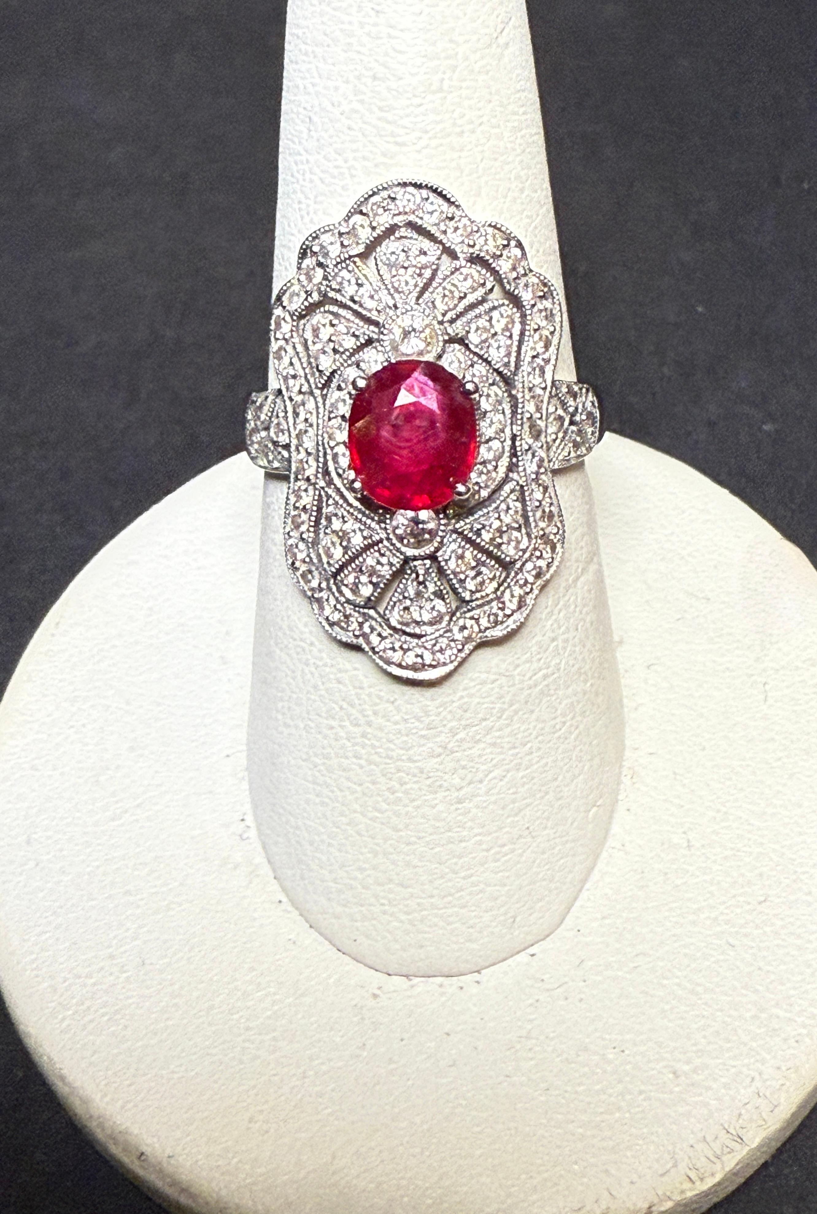 Art Deco style oval 14K white gold diamond and ruby ring. Oval ruby surrounded by 90 round cut diamonds makes for an elegant dazzling ring for any occasion.
Oval Ruby approx. weight 1.0cts
90 round cut diamonds approx. weight .45cts.
Weight