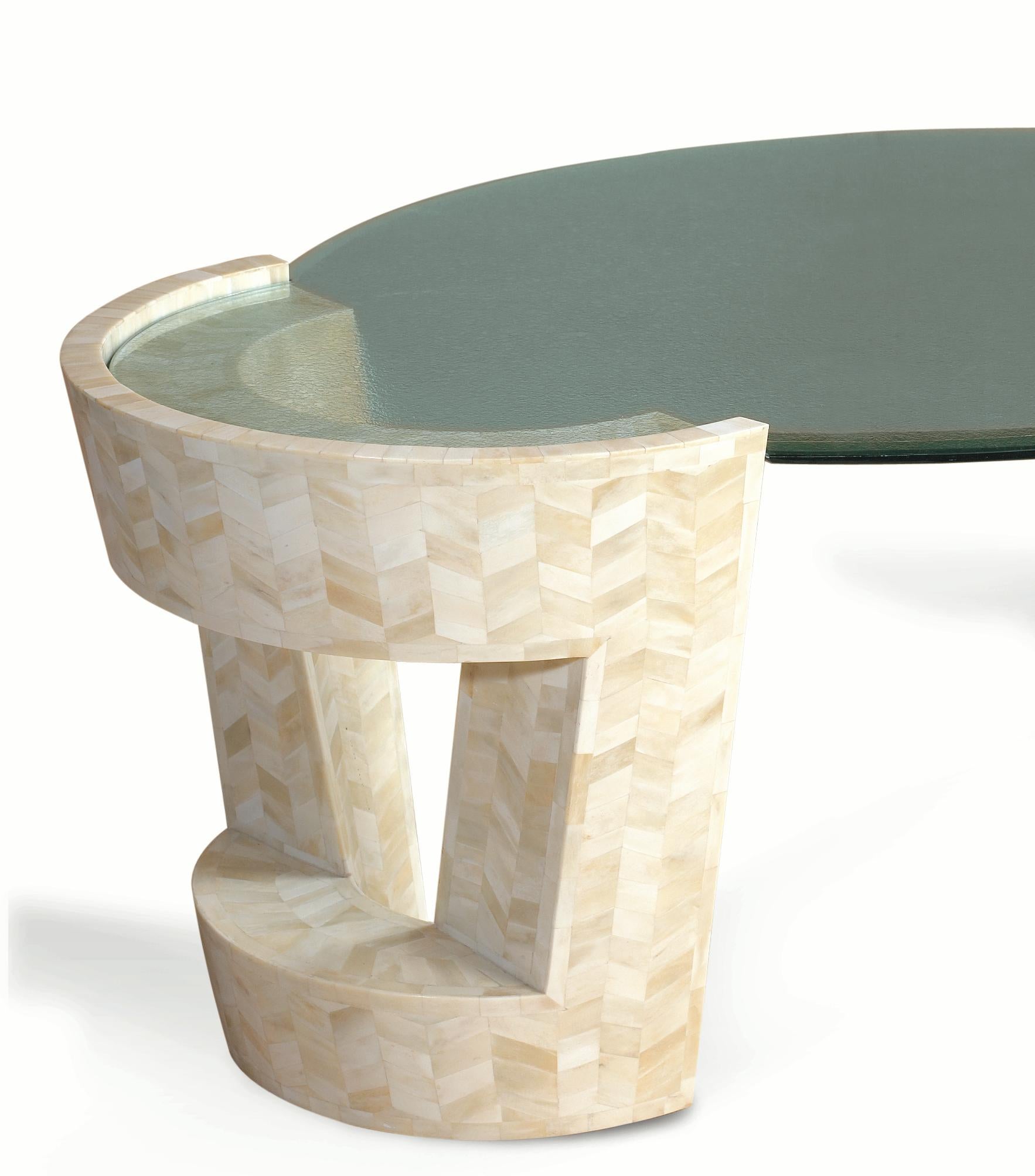 Solid wood curves coated with creamy camel bone chips give this piece its name. Fitted with a frosted glass top that connects the handcrafted crescents, the Cheesecake Table is delectably unique.

Size: 33