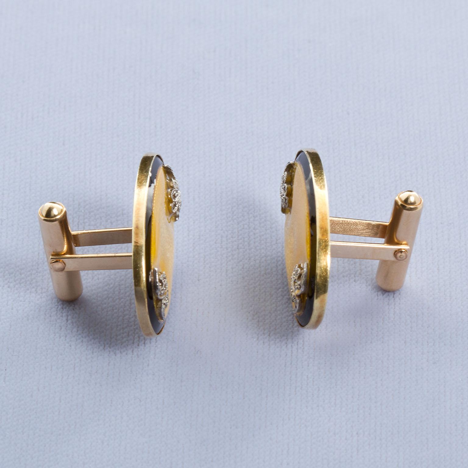 A dashing pair of diamond and gold cufflinks with black and clear enamel on yellow gold Guilloche style. These cufflinks exude a gentlemanly charm of the old days with magnificent Fleur-de-lis diamond in platinum accents at the two ends of each