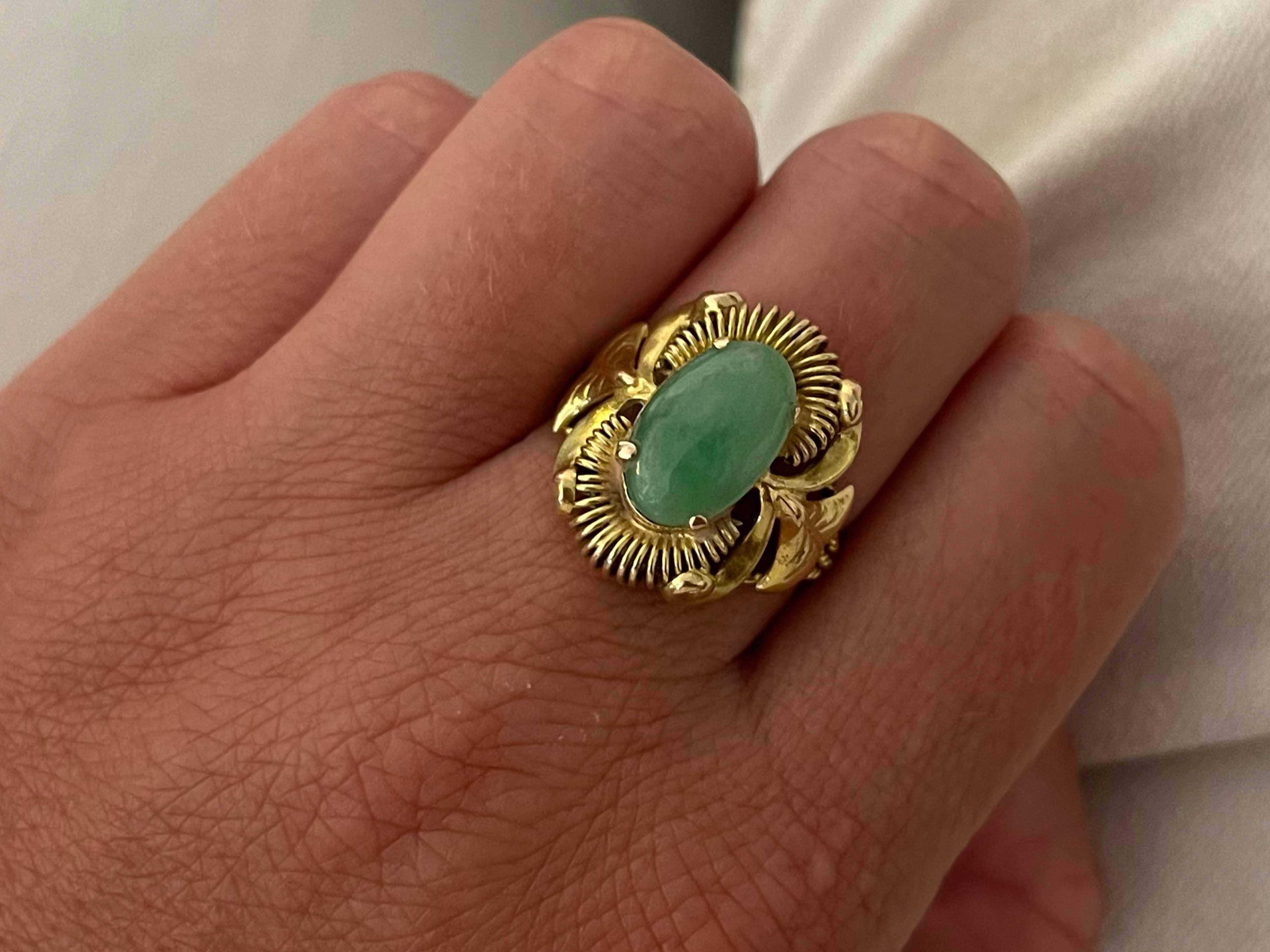 Item Specifications:

Metal: 14K Yellow Gold 

Style: Statement Ring

Ring Size: 7.25 (resizing available for a fee)

Total Weight: 5.6 Grams

Gemstone Specifications:

Center Gemstone: Jade

Shape: Oval

Color: Green

Cut: Cabochon 

Jade Carat