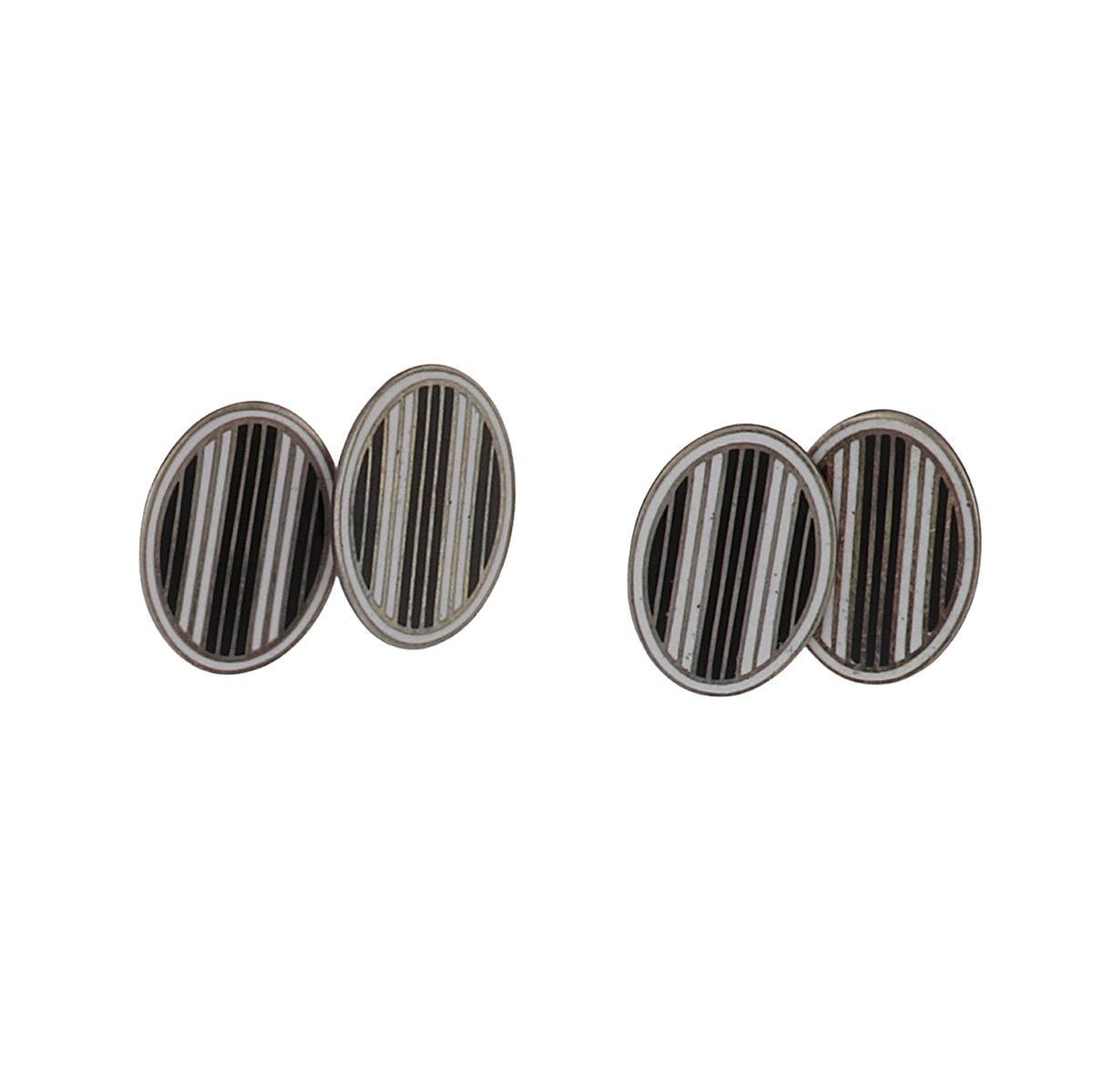 Art Deco double-sided oval shaped silver cufflinks with black and white enamel stripes. Circa 1920.
