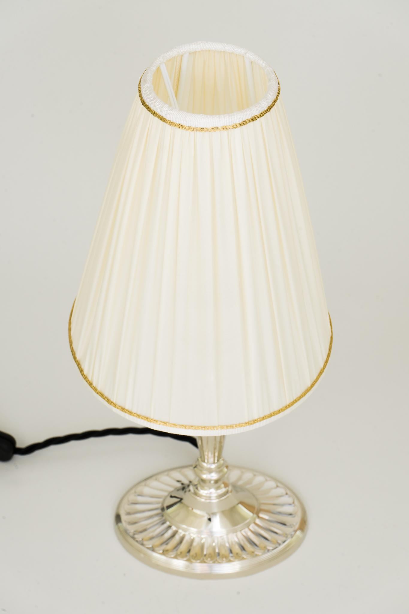 Art Deco oval table lamp alpaca with fabric shade, circa 1920s
Polished and stove enamelled
Shade is replaced (new).