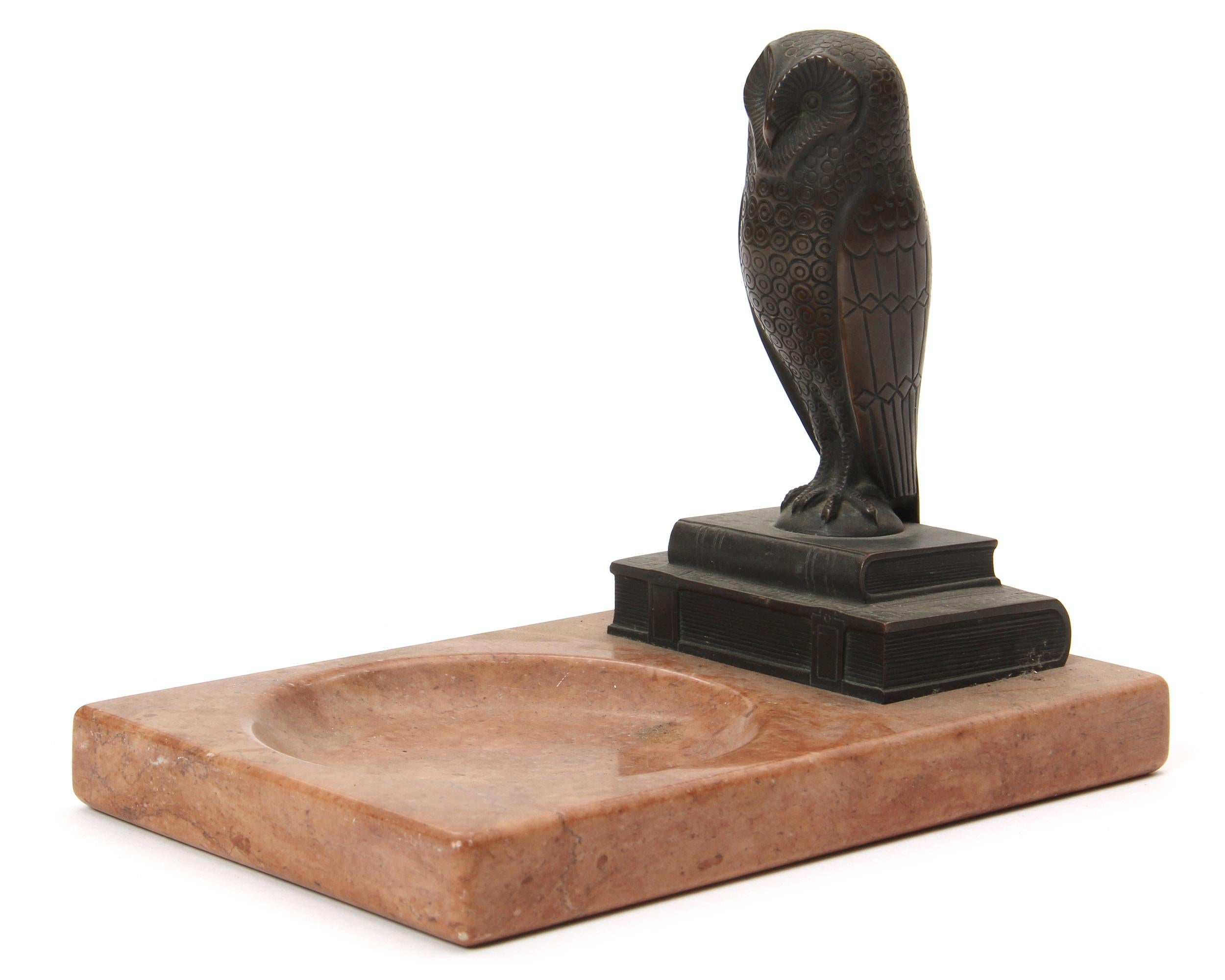 An Art Deco marble ashtray with a bronze owl standing on two books, circa 1940s.