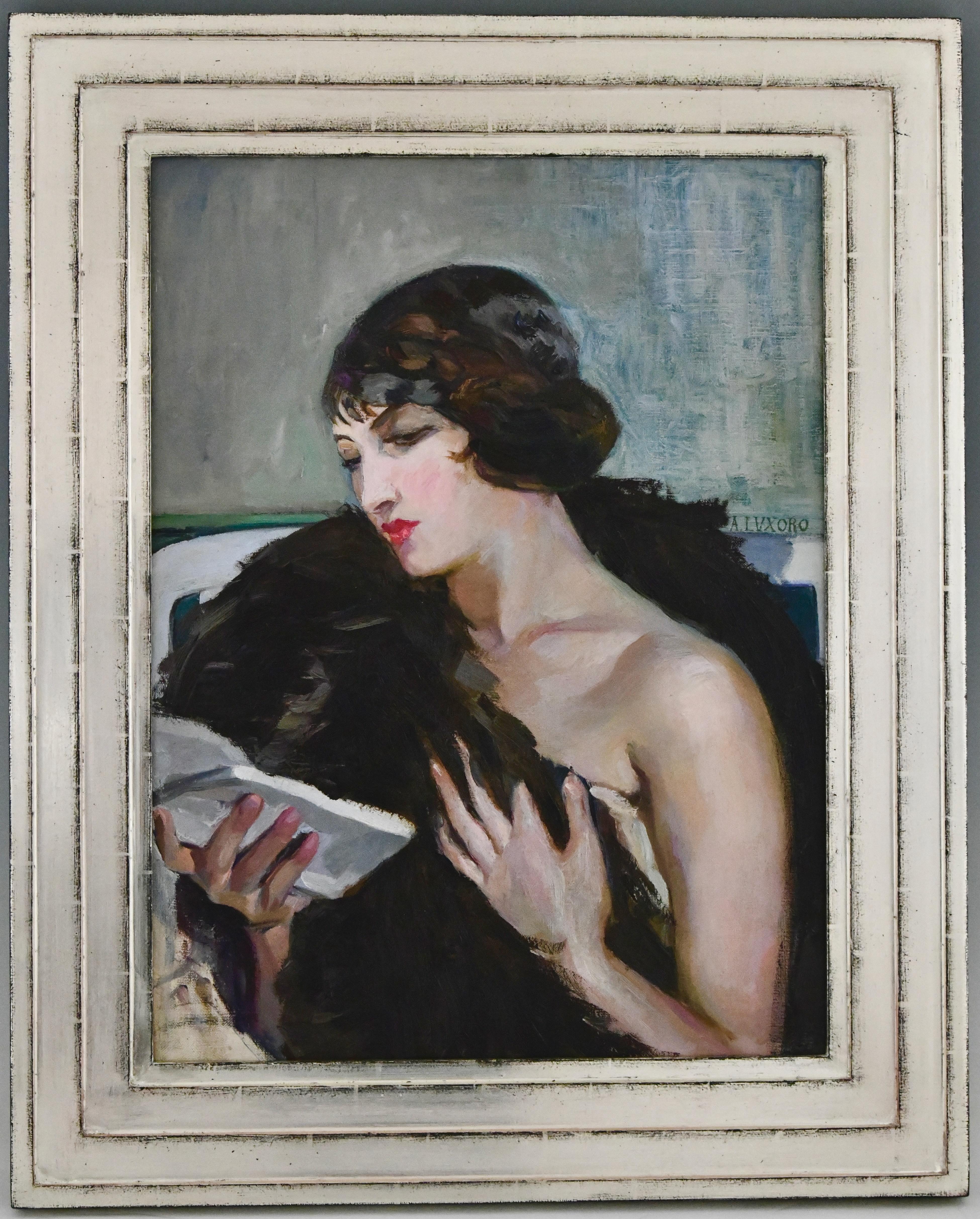 Art Deco painting elegant lady with book by Alfredo Luxoro, Italy 1859-1918.
Oil on canvas. Ca. 1910. 
Handmade silver leaf frame by Gehring & Heijdenrijk. 
With Certificate of Authenticity. 
Size framed:
H. 76.5 cm x L. 62 cm x D. 4 cm
H.