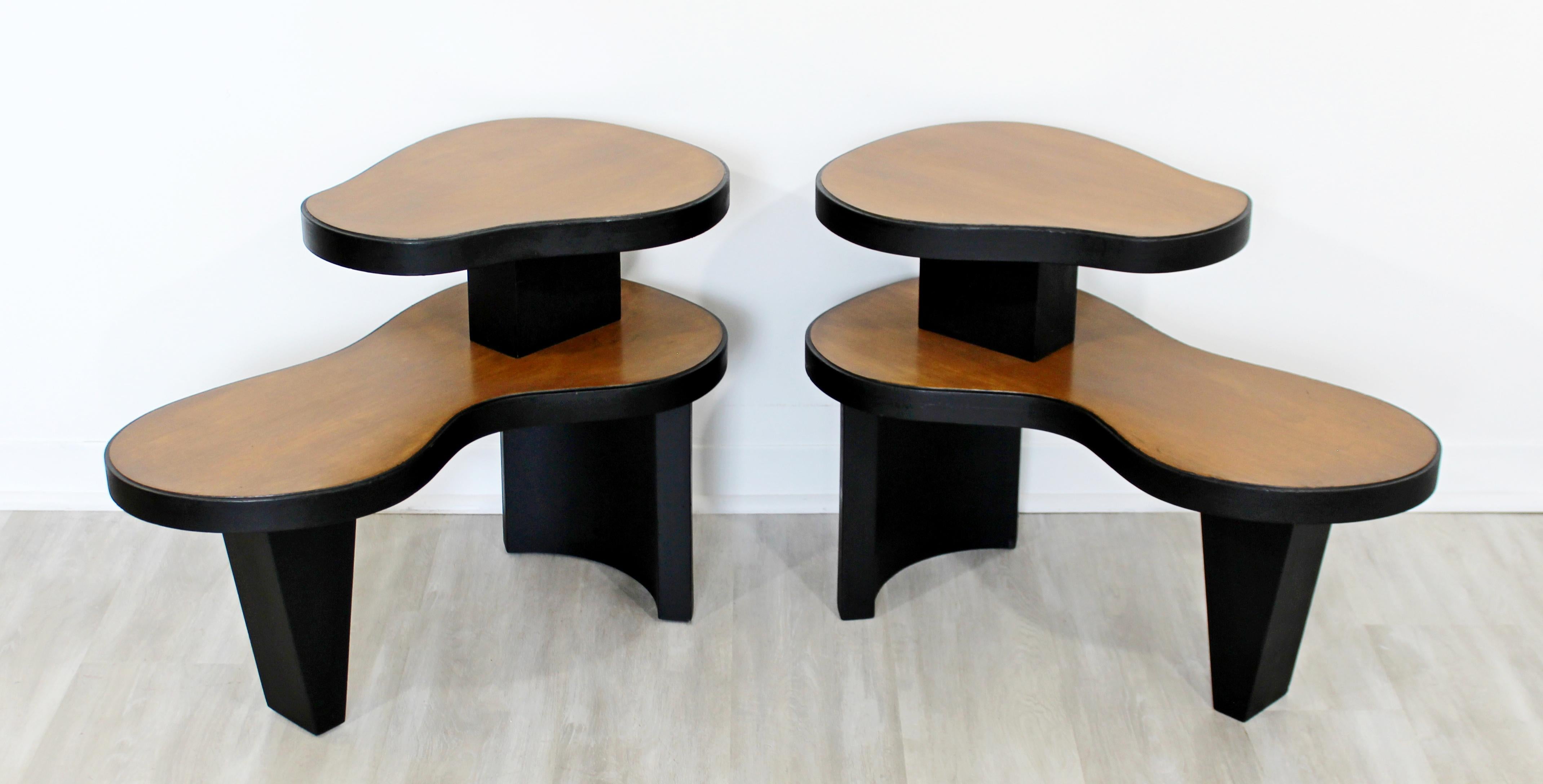 For your consideration is a magnificent pair of two tiered, Art Deco, amoeba shaped wood side or end tables, circa 1940s, in the style of Gilbert Rhode or Donald Deskey. In very good antique condition. The dimensions are 29