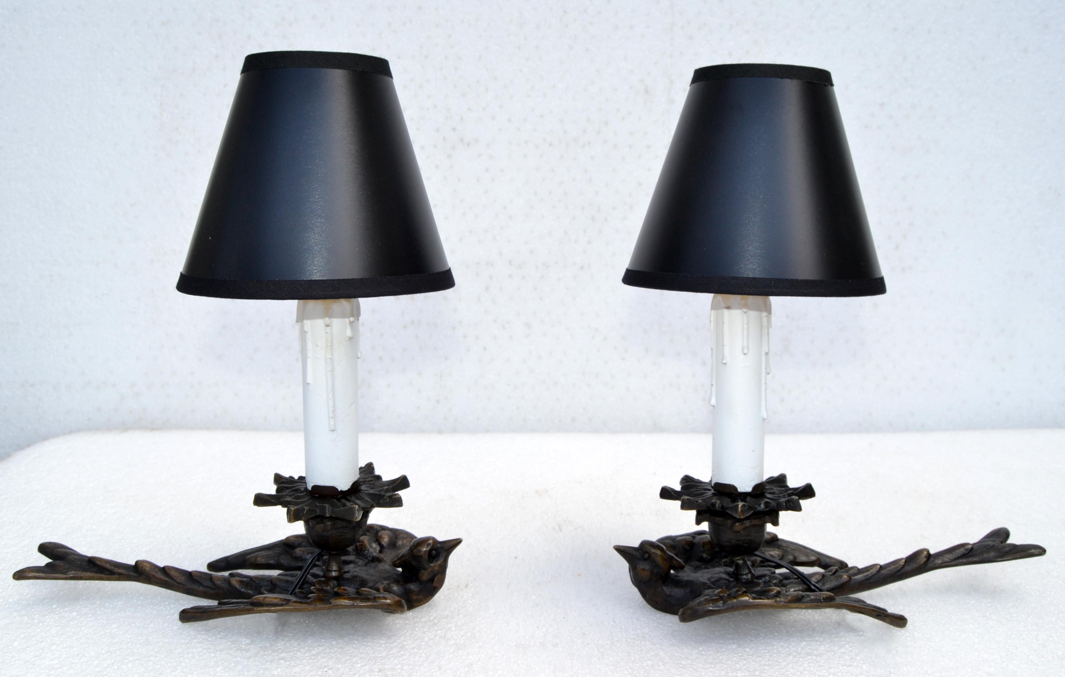 Pair of nice one off a kind Art Deco 1940 night stand table lamps with beautiful swallow bird statue made off bronze and they have a nice creme white / yellow colored sleeve and come with black & gold paper shades.
The lamps have been rewired and
