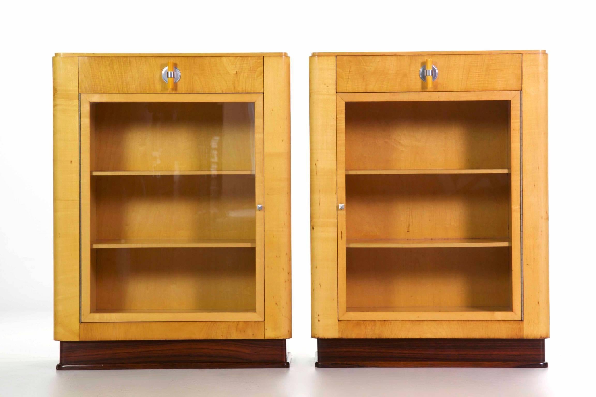This pair of bookcases with their single drawer are designed with the very essence of the Art Deco movement expressed fully in their form. Angular and free of any excessive surface embellishment, they explore the newest and most innovative materials