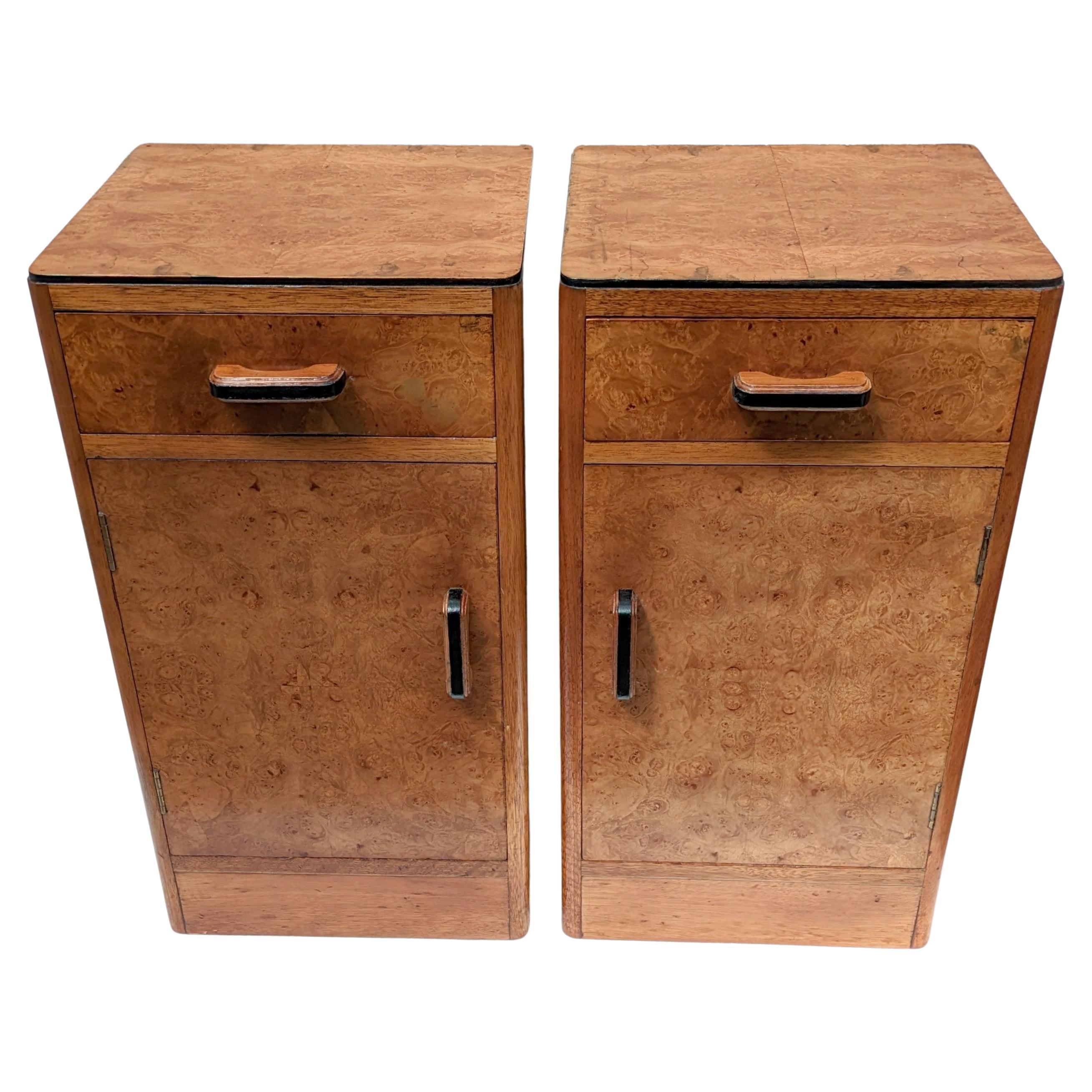 Fabulous pair of matching 1930's Art Deco bedside tables in heavily figured maple veneer with original ebonised wooden handles and ebonised accents. Two generously sized internal storage areas. Each cabinet has a pull out upper drawer which works
