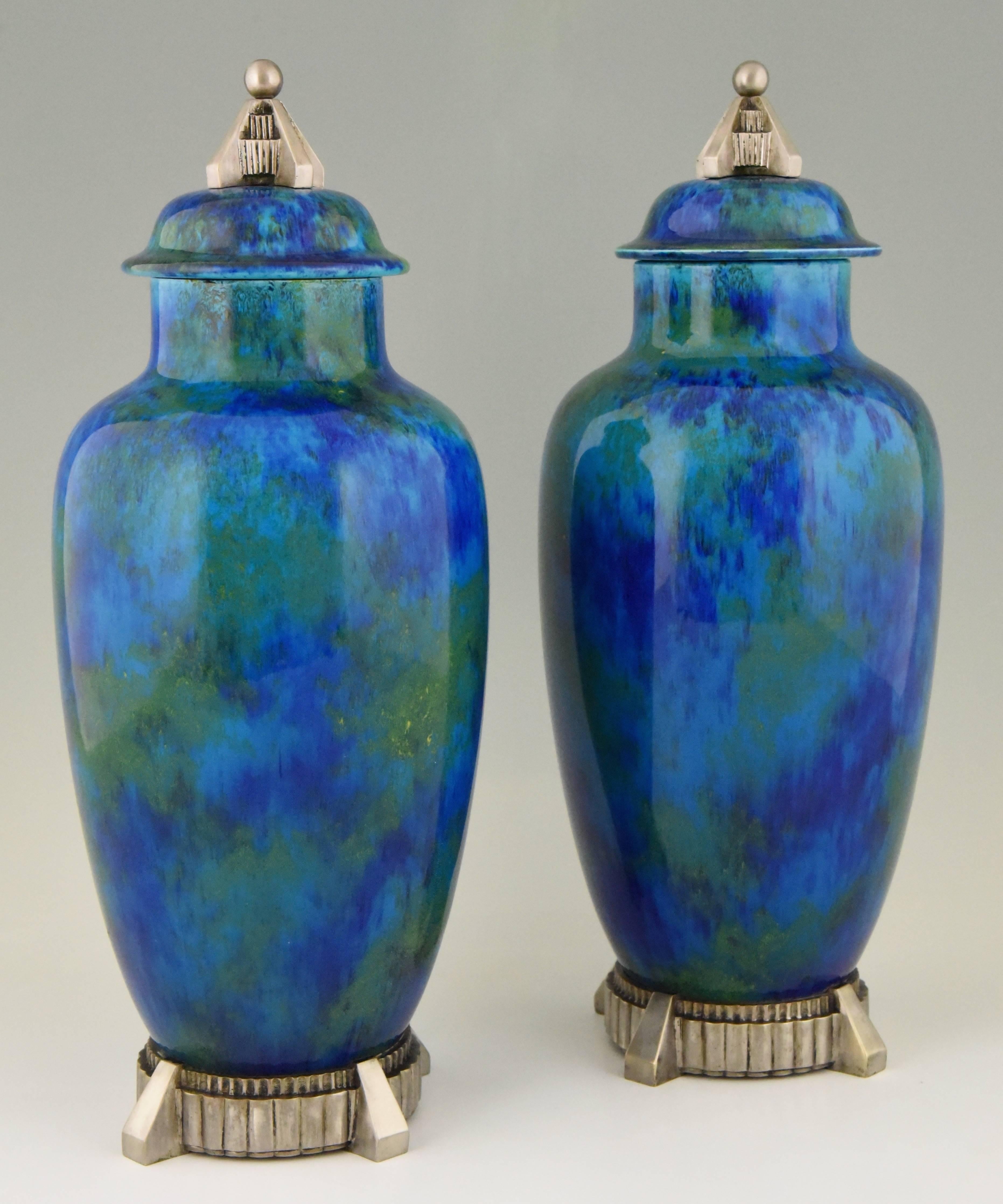 A beautiful pair of Art Deco ceramic vases or urns with blue glaze with bronze silvered decorations. The vases are created by Paul Milet for Sèvres, France 1925
 