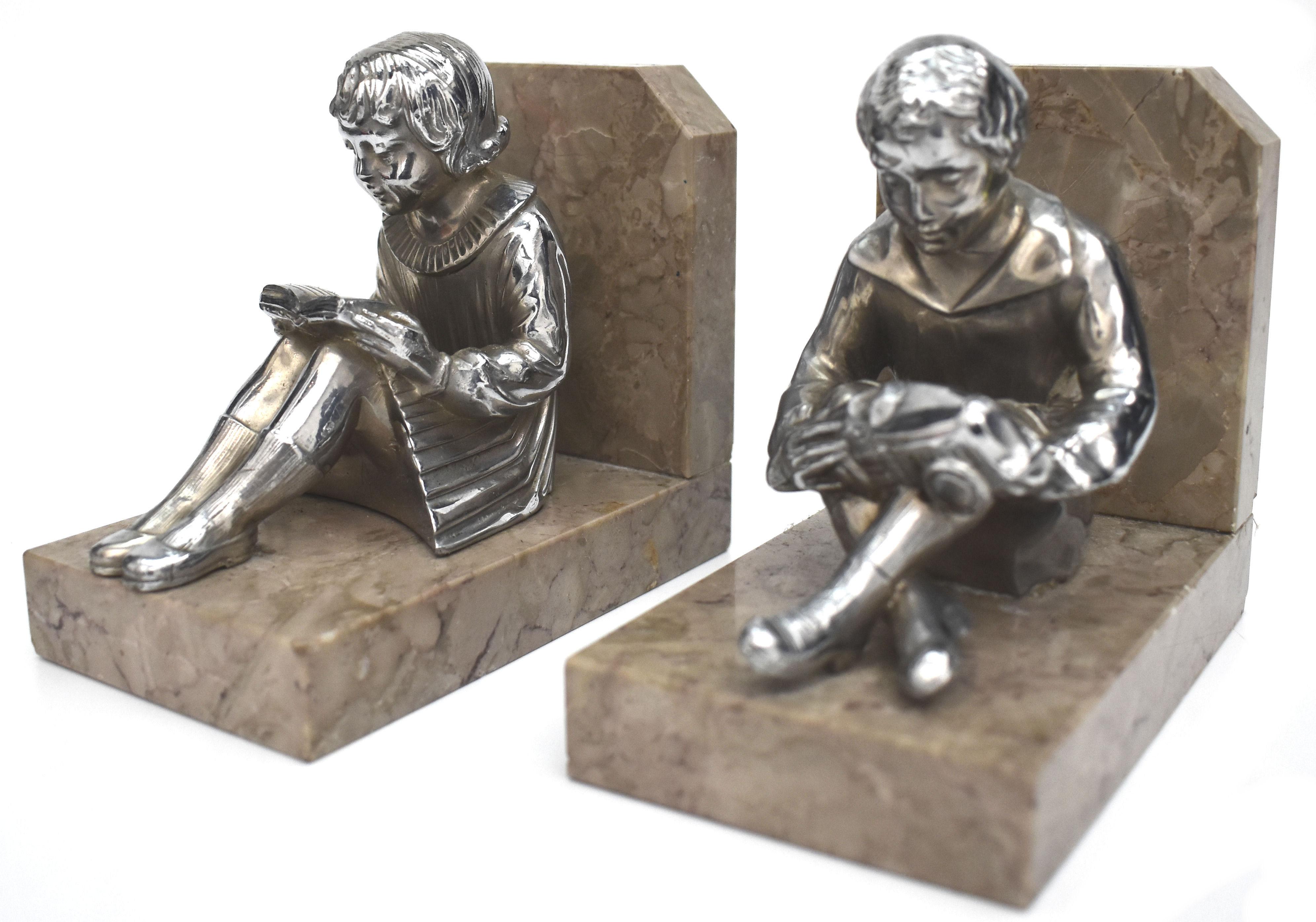 Very stylish and rare matching pair of Art Deco bookends. These are a great find and in exceptional condition. Originating from France and dating to the 1930s both stand on marble bases and depict a young girl and boy in chromed spelter. Lovely