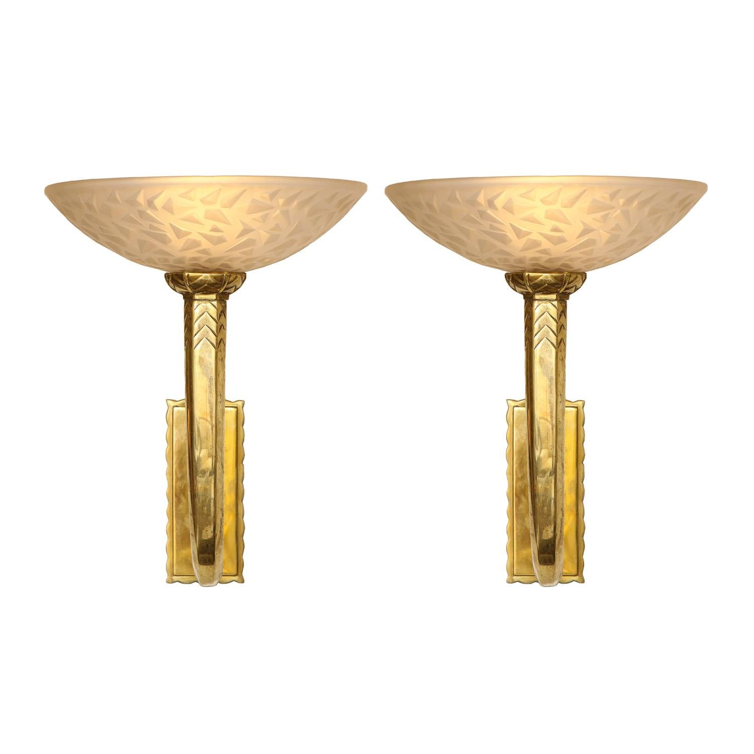 Deco period pair of bronze wall sconces with etched, frosted glass bowl and chevron incised body.
Dimensions:

Width: 11 inches
Depth: 12 inches
Height: 12 inches

Back Plate: 
Width: 3 inches
Height: 6.75 inches

