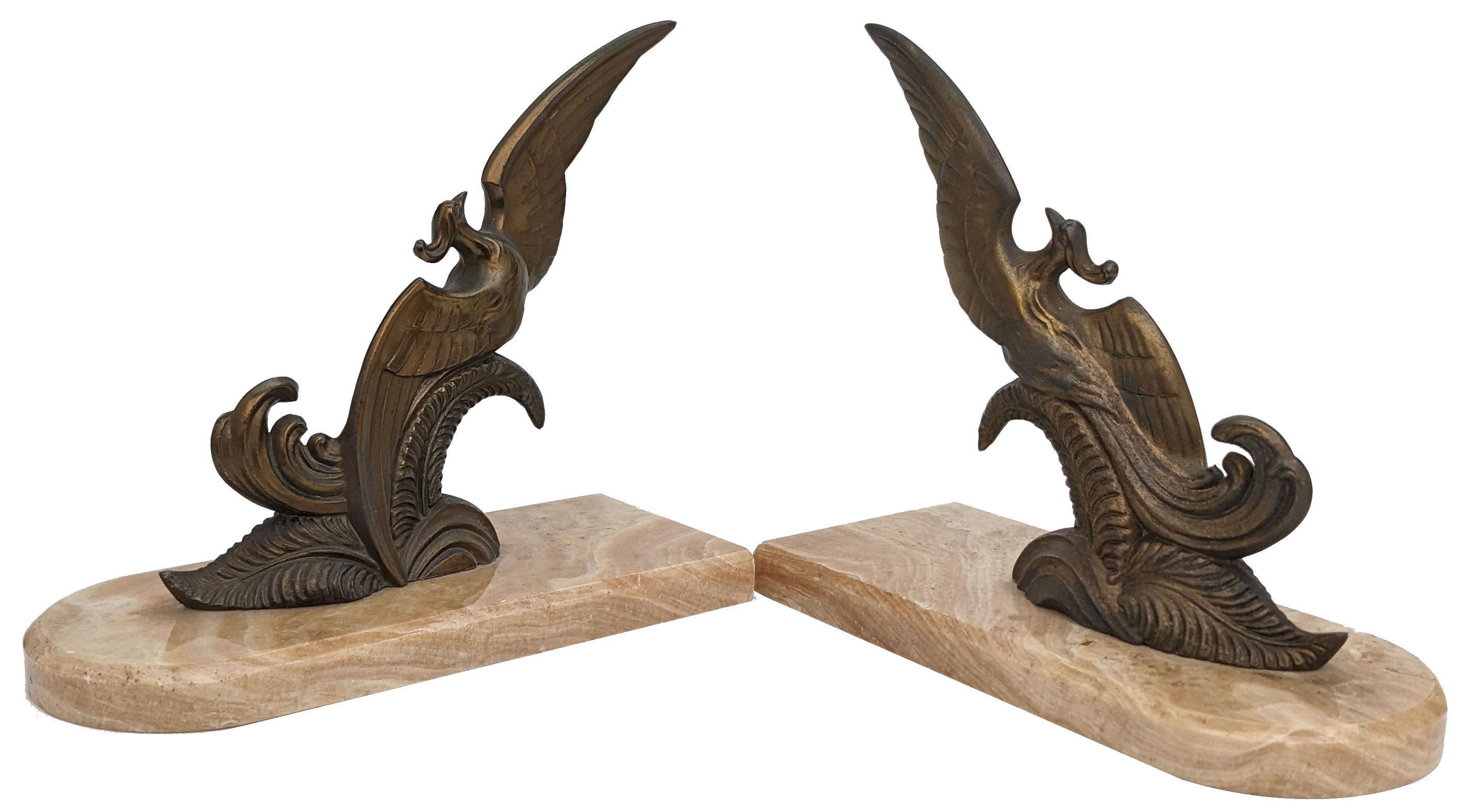 Very stylish and rare matching pair of Art Deco bookends. These are a great find and in exceptional condition. Originating from France and dating to the 1930s both stand on marble bases and depict stylized birds in cold painted spelter and rest on