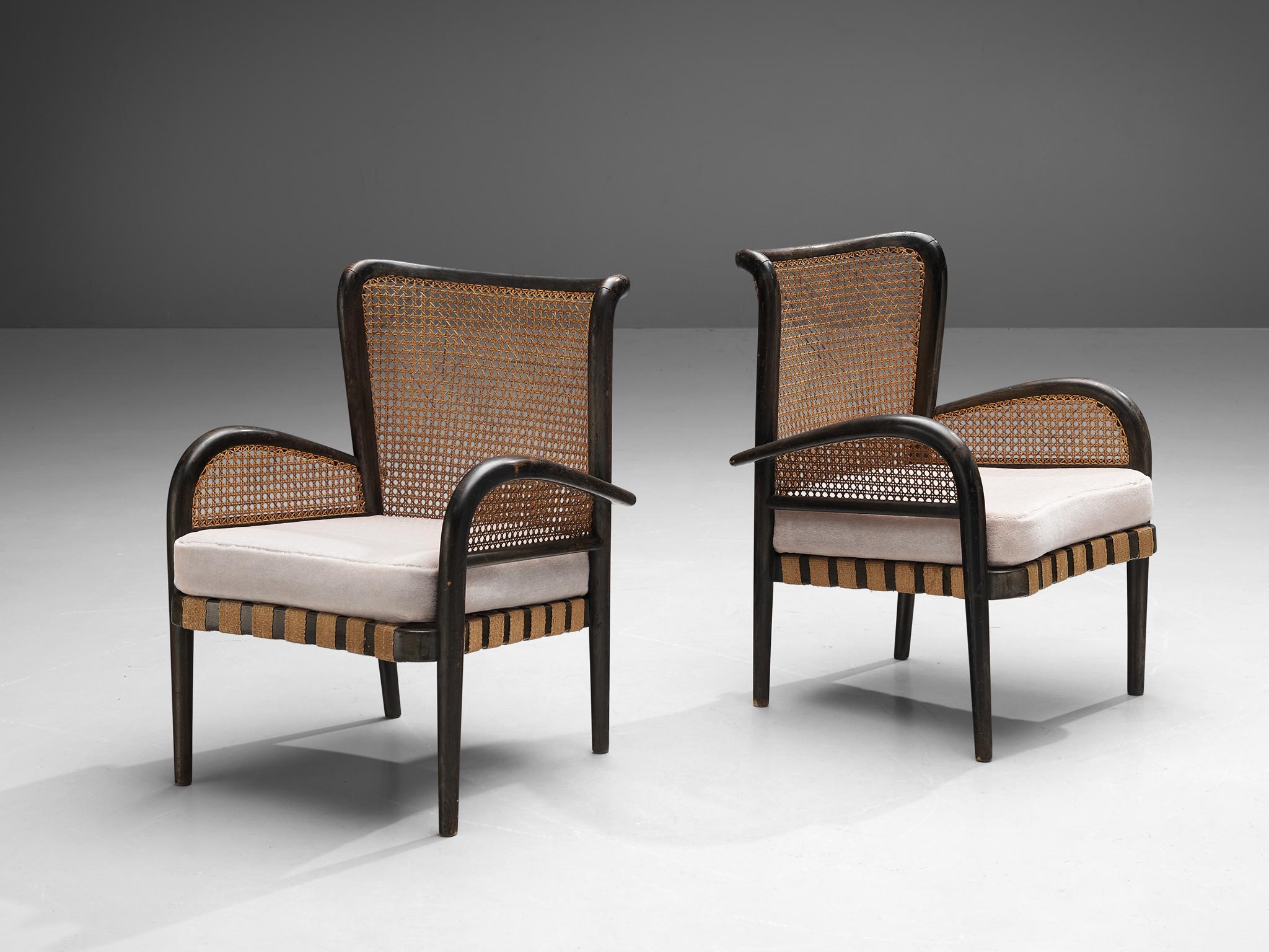 Pair of lounge chairs, cane, velvet fabric, beech, jute, France, 1960s

This pair of lounge chairs has a splendid construction that epitomizes a simplistic, natural and timeless aesthetics. The design is characterized by bentwood showing clear,