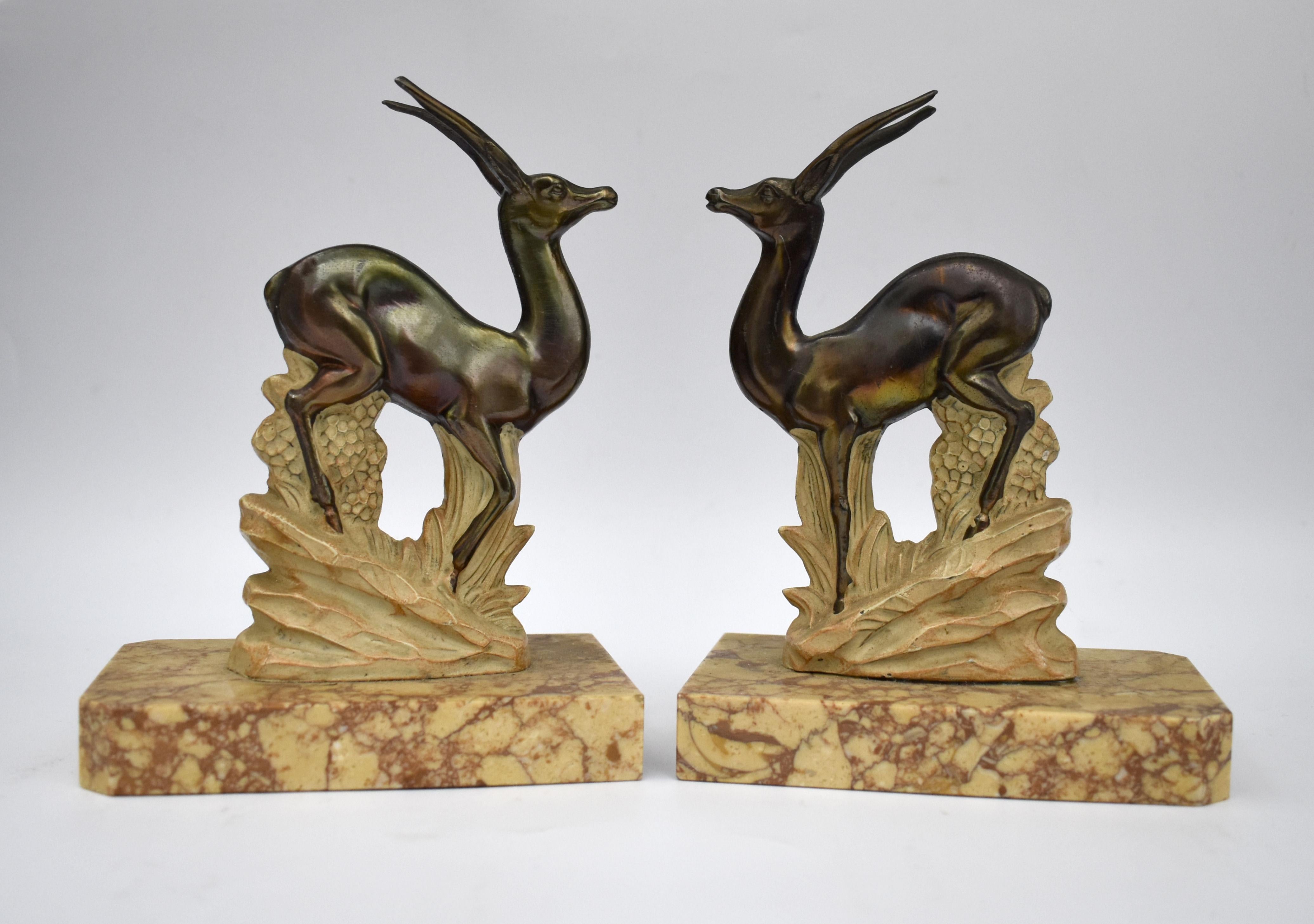 Very stylish and rare matching pair of 1930's Art Deco bookends. These are a great find and in exceptional condition. Originating from France both stand on marble bases and depict stylized antelope in spelter which have been cold painted.