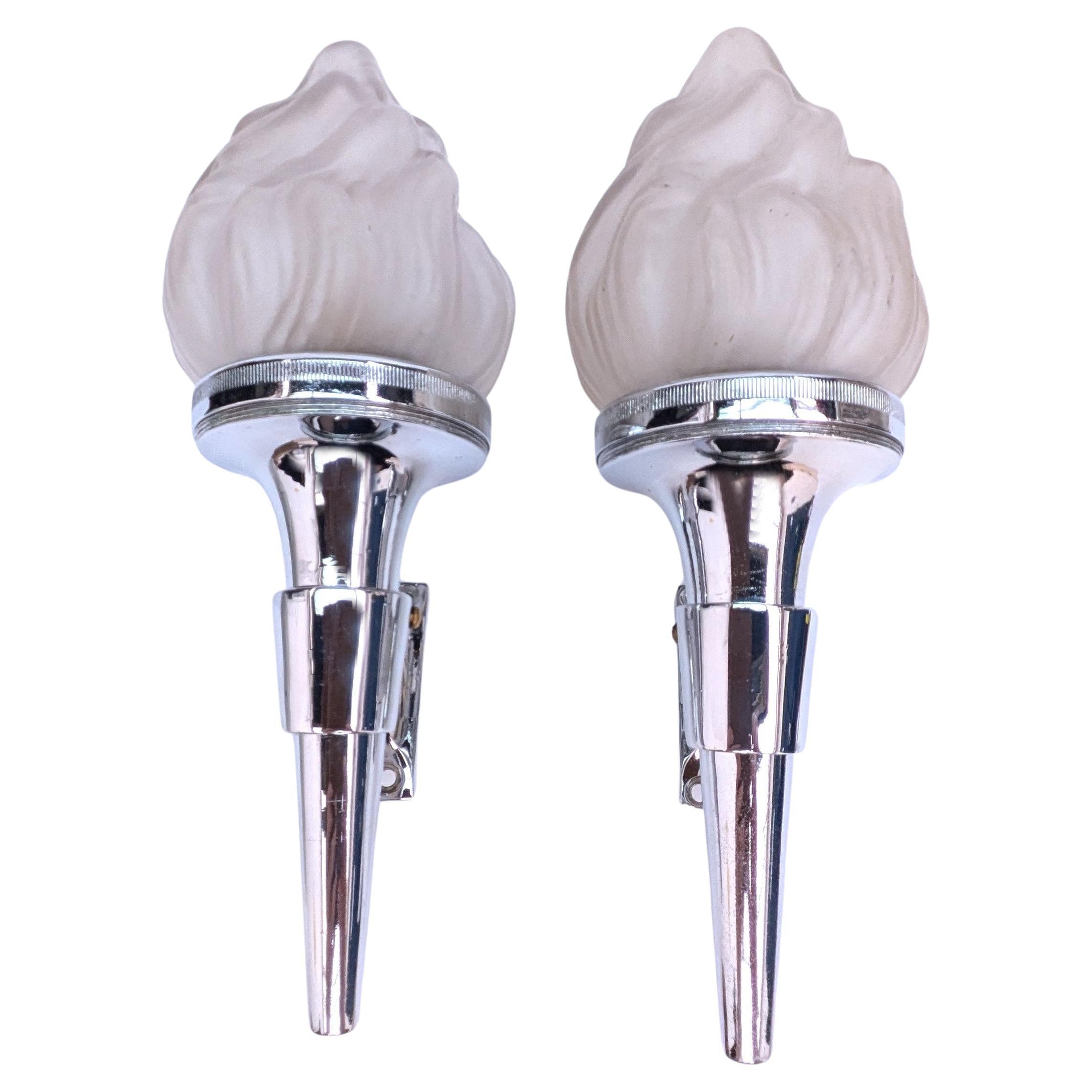 A very rare chance to acquire a pair of matching Art Deco wall light sconces. Made from chrome metal-ware, all with original frosted glass flame shades. These lights make a great statement to any room. All the lights are in good vintage condition. 