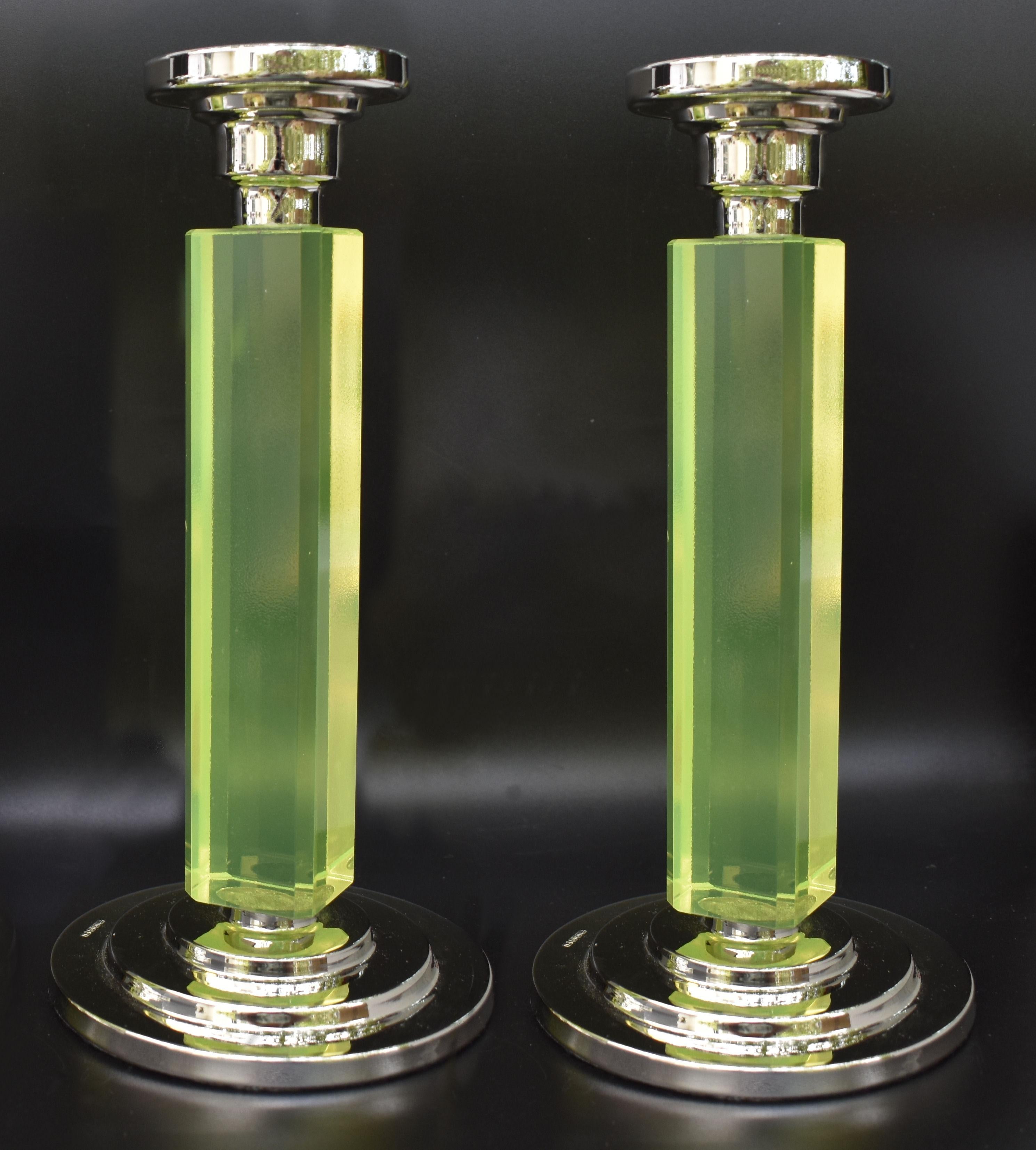Superbly stylish and good sized pair of matching 1930s Art Deco candlesticks. Hallmarked nickel-silver bases and with tall uranium glass columns. Lovely condition and one Art Deco admirers will appreciate. Felt bases have been added to the bottom of
