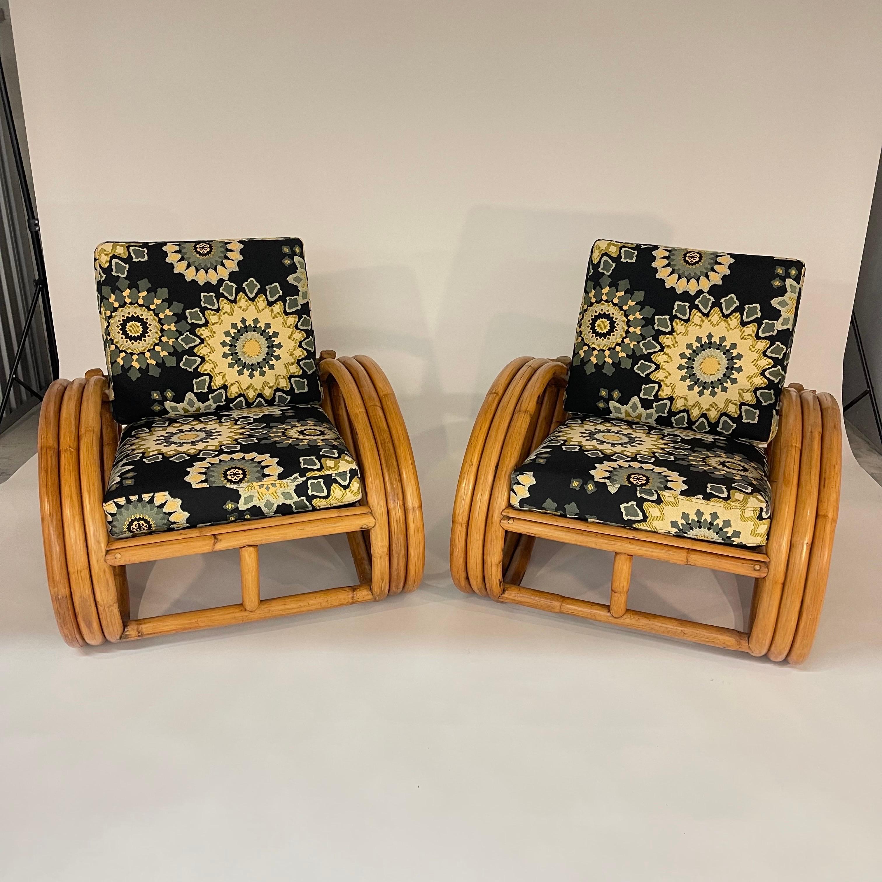 Unique Vintage Art Deco Three Band Rattan Pretzel Club Lounge or Armchairs, rendered in bent rattan frame, recently reupholstered in a Moroccan print high end woven fabric with a jute webbing base and adjustable three position back, in the style of