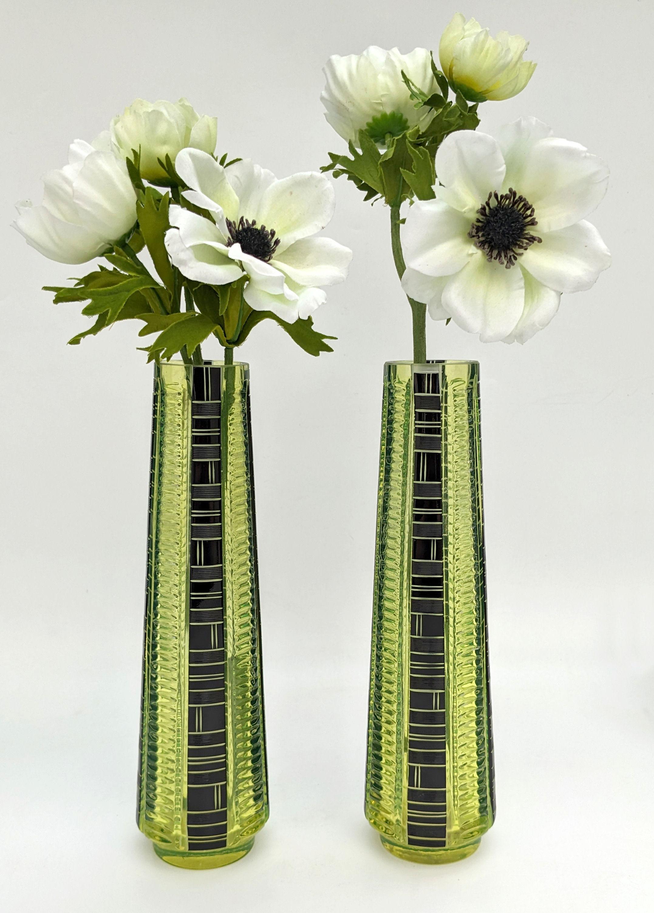Very stylish and appealing Art Deco matching pair of uranium cut glass vases. The colour is a lemon yellow with black enamelling and etched accents and the condition is excellent, some clouding in the bases , no damage, all are free from chips,