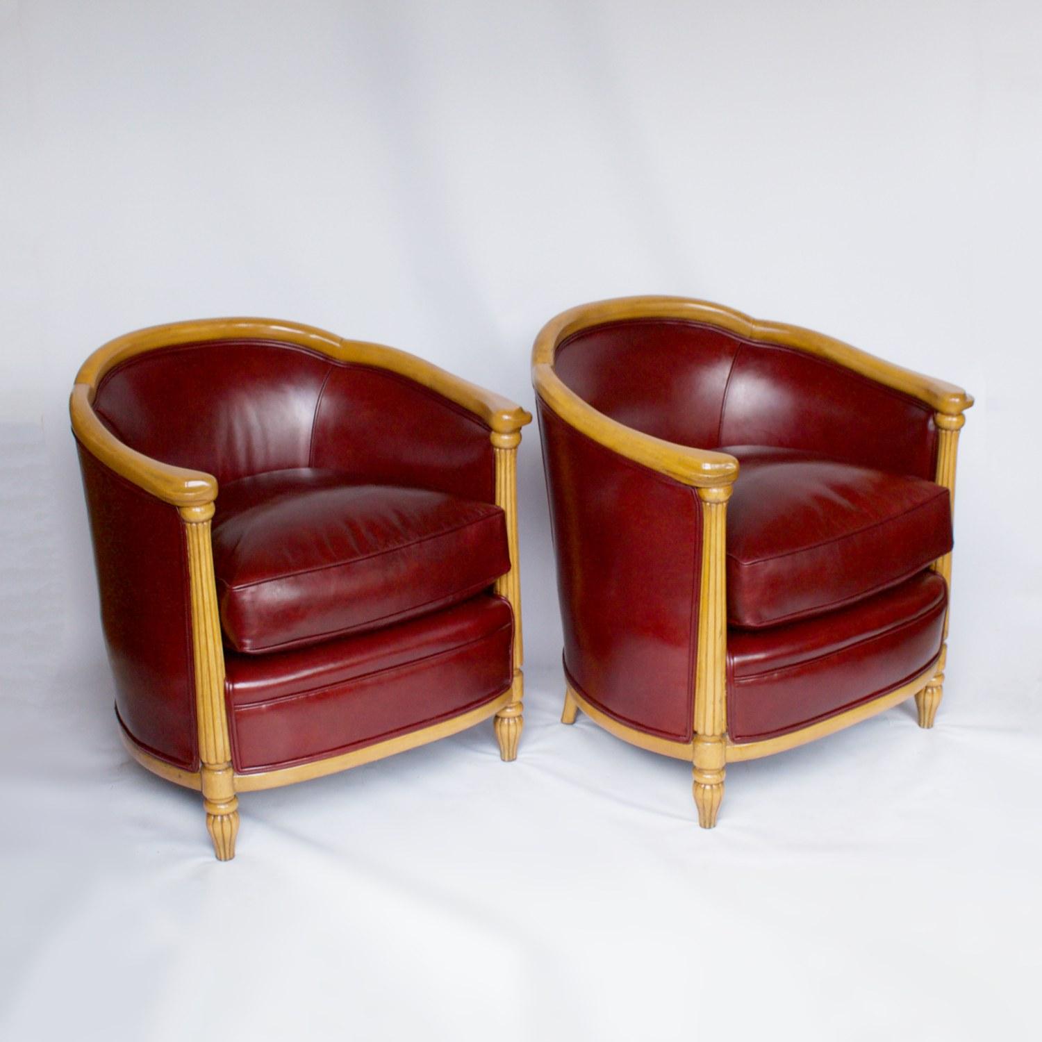A pair of Art Deco tub chairs with reeded front column legs and curved frame with carved hand rest detail. Solid beech, upholstered in red leather. 

Dimensions: 76.5cm W 69cm D 63cm, seat H 47cm

Origin: English

Date: circa 1935

Item