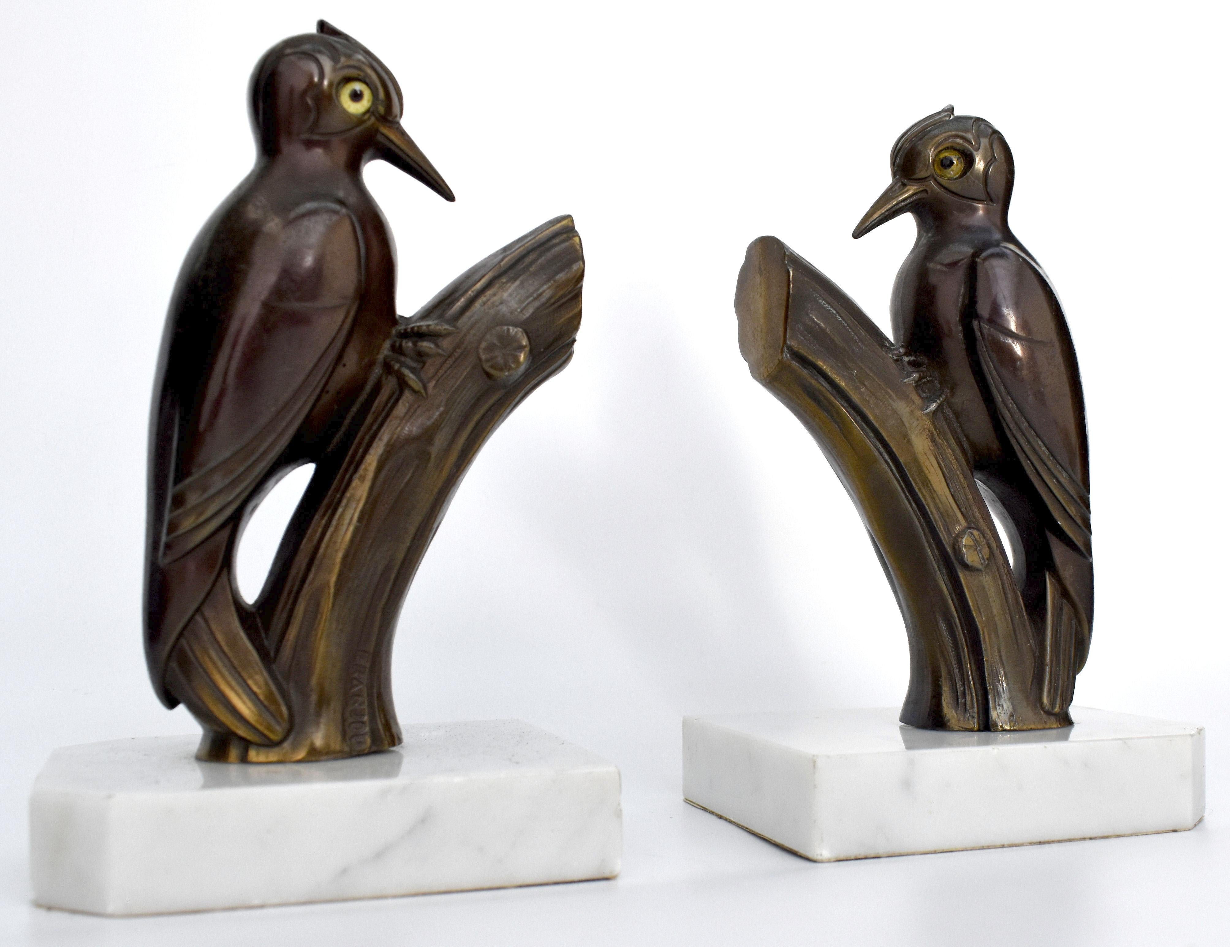 Very stylish and rare matching pair of Art Deco bookends. These are a great find and in exceptional condition. Originating from France and dating to the 1930s both stand on marble bases and depict stylized woodpeckers in spelter which have been cold