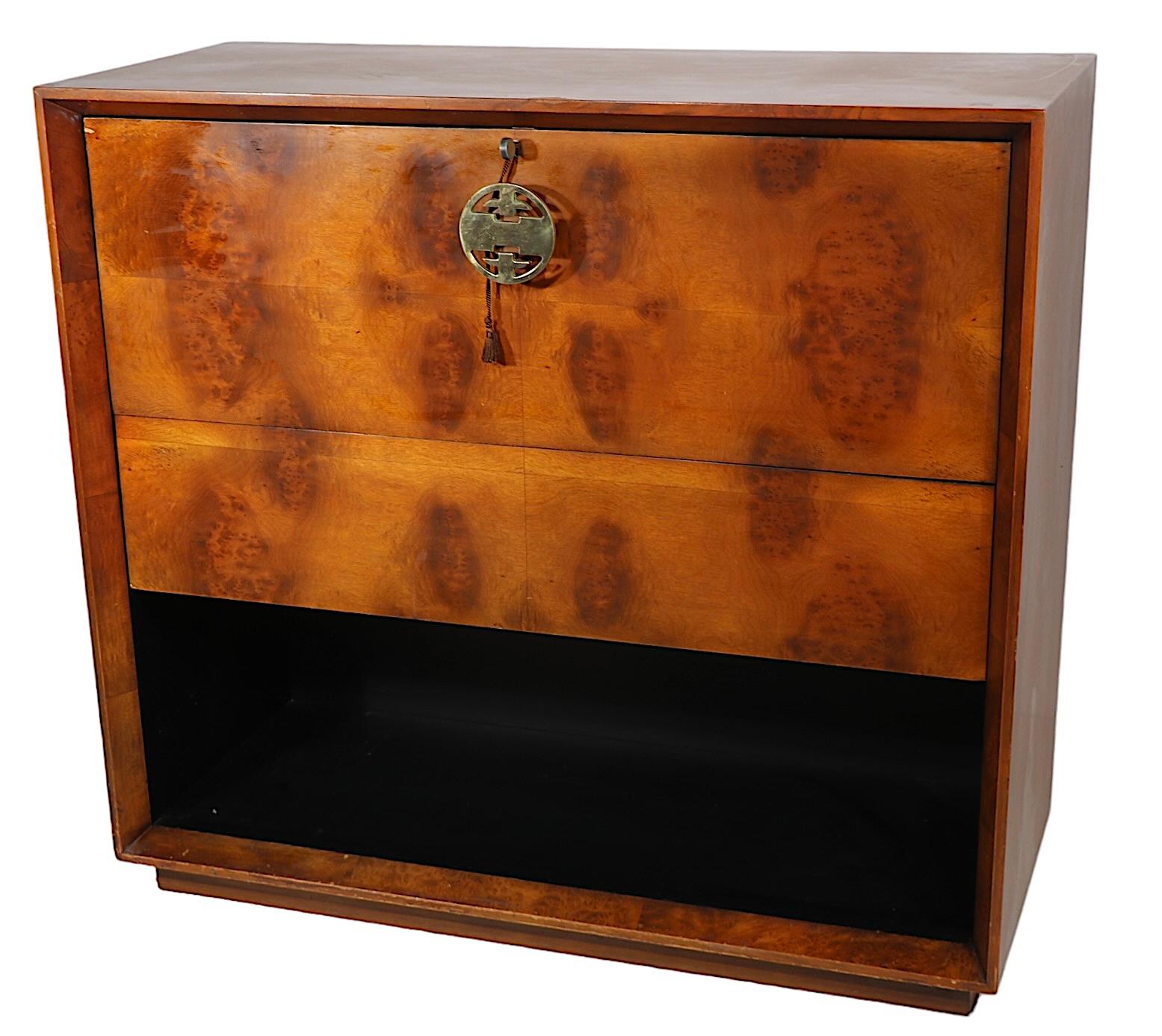 Elegant and sophisticated drop front desk designed by Gilbert Rohde for Herman Miller as part of the much sought after Palladio series, circa 1940’s.
The desk features a burl veneer fall front, over burl front drawer, over an open storage space with