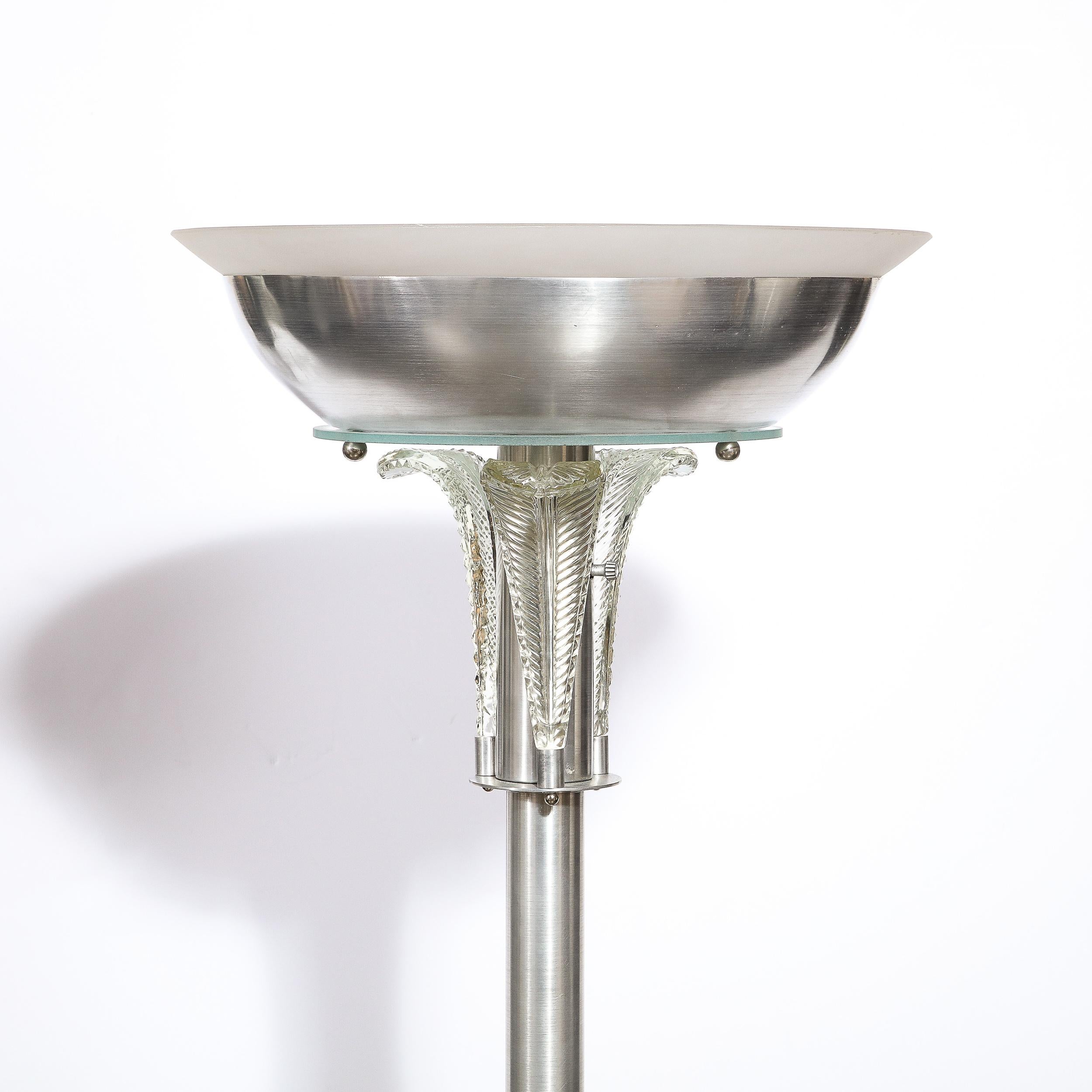 This stunning Art Deco torchiere was realized by the legendary Walter Von Nessen in the United States circa 1940. Executed in polished aluminum (the material for which Von Nessen is most renowned) the torchiere offers a volumetric circular base from