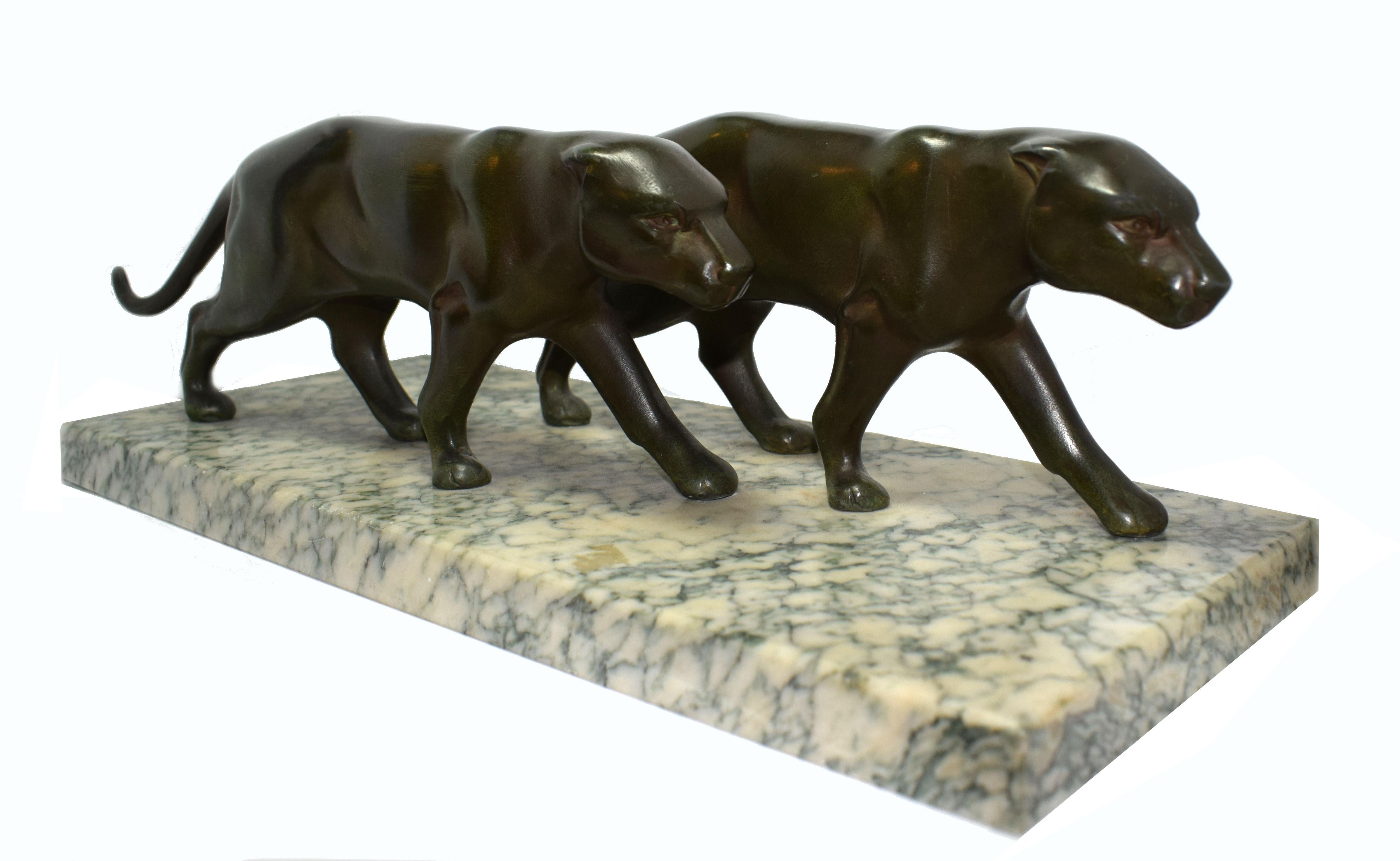 An impressive and large 1930s Art Deco pair of strolling panther figures on a mottled green and off white colour marble base. Wonderful patina and in great condition this figure shows real quality. Beautiful detailing, a real sense of muscle tones