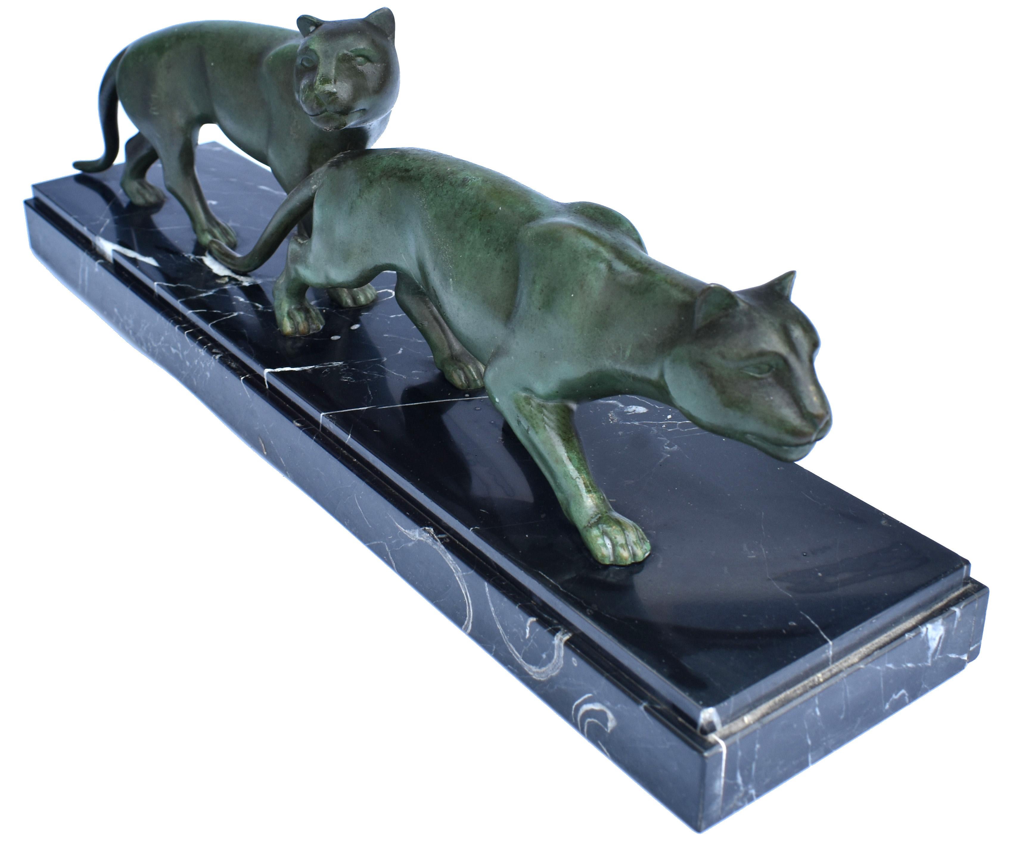 An impressive and large 1930s Art Deco pair of strolling Panther figures on a black marble base. Wonderful patina and in great condition this figure shows real quality. Beautiful detailing, a real sense of muscle tones and movement. Made from