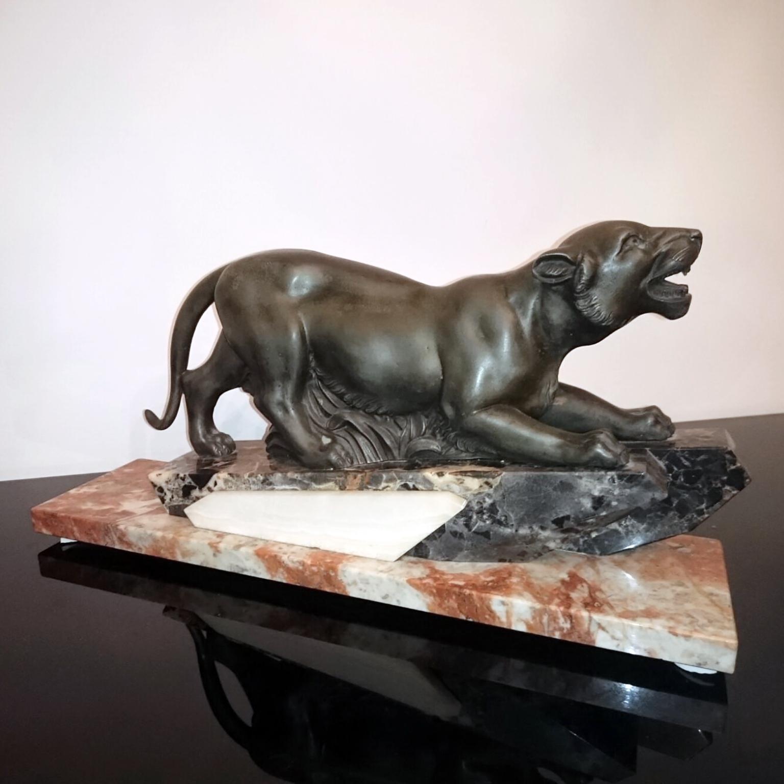 Art Deco sculpture depicting a stalking panther, France, circa 1930
Green patinated régule panther on a rectangular, profiled pedestal of white veined, black and red marble.

Dimensions:
Length 46cm (18.11 in.), depth 12cm (4.73 in.), height