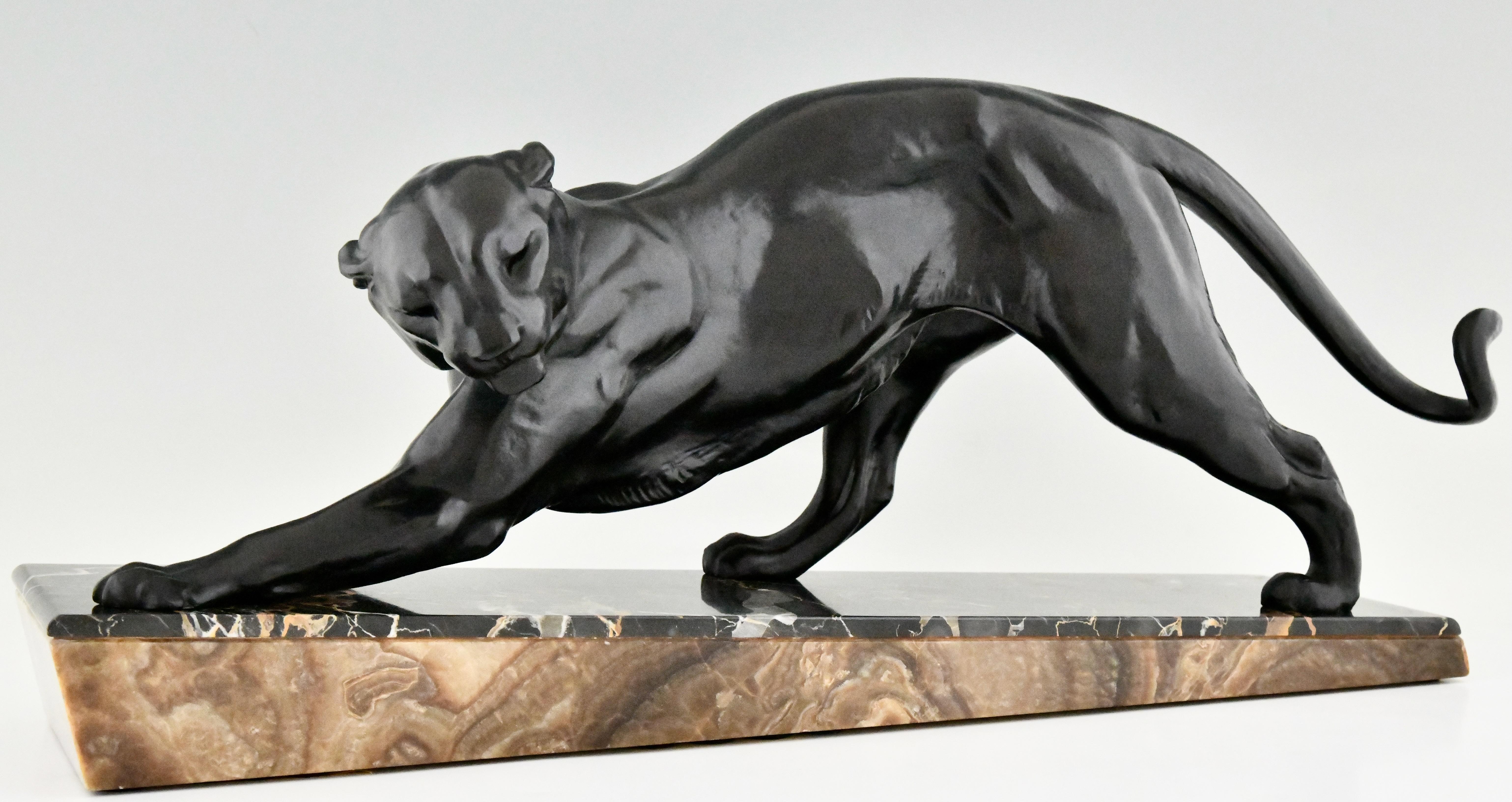 Art Deco panther sculpture by the French artist Plagnet. 
The Art metal sculpture has a lovely black patina and stands on a Portor and brown marble base. 
France ca. 1930.