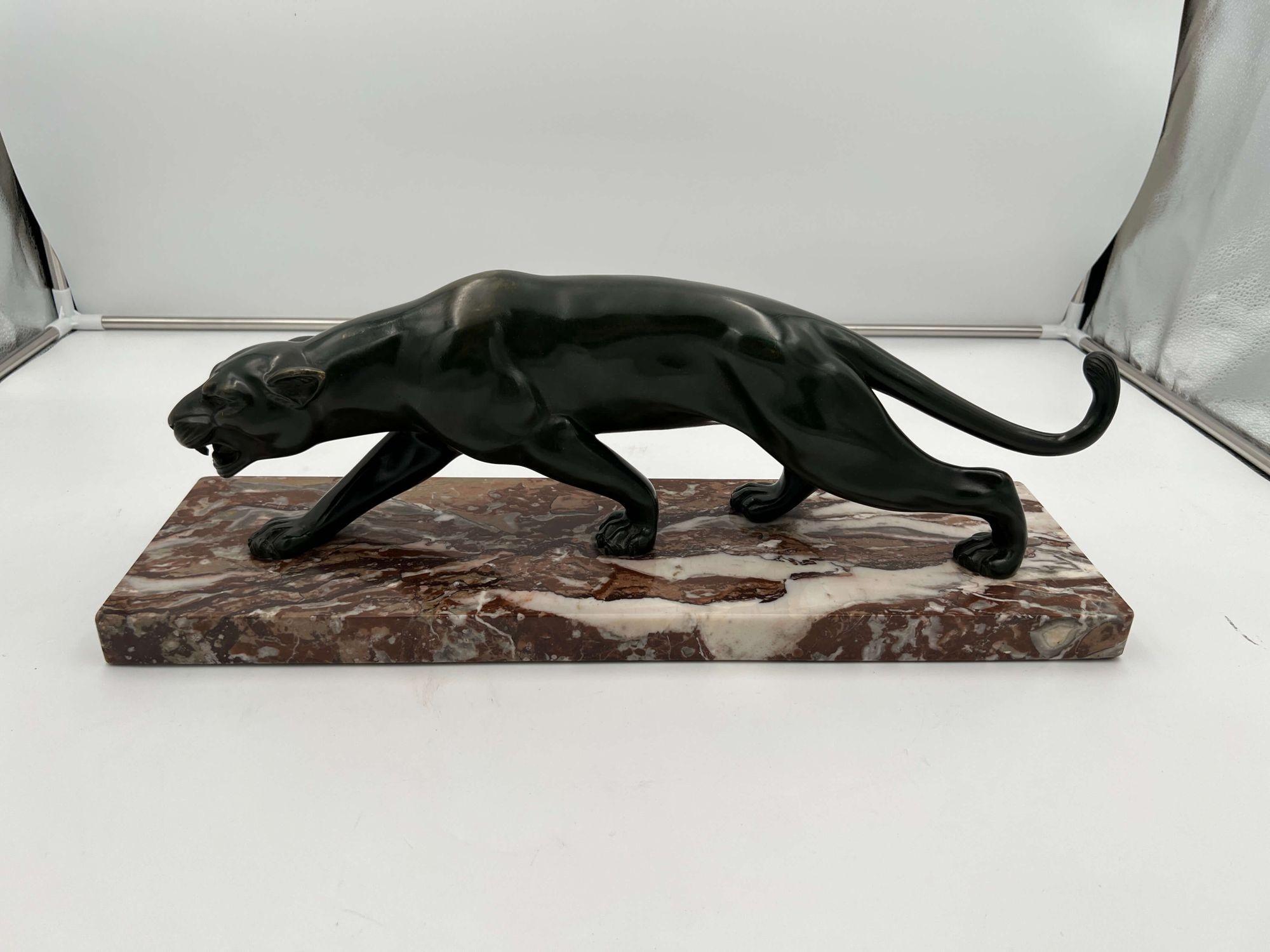 Very elegant Art Deco bronze sculpture of a striding panther from France about 1930.
Signed on the leg by sculptor Salvatore Melani (1902 - 1934). Bronze, greenish patina. Red marble base.
Dimensions: H 19 cm x W 55 cm x D 16 cm (incl. marble plinth)