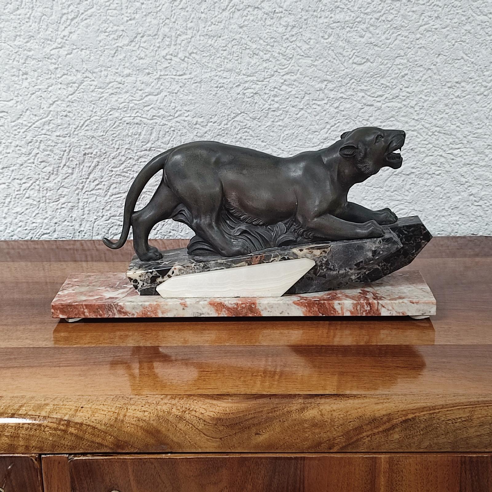 Art Deco sculpture depicting a stalking panther, France, circa 1930
Green patinated spelter panther on a rectangular, profiled pedestal of white veined, black, and red marble.

Dimensions:
Length 46cm (18.11 in.), depth 12cm (4.73 in.), height 21cm