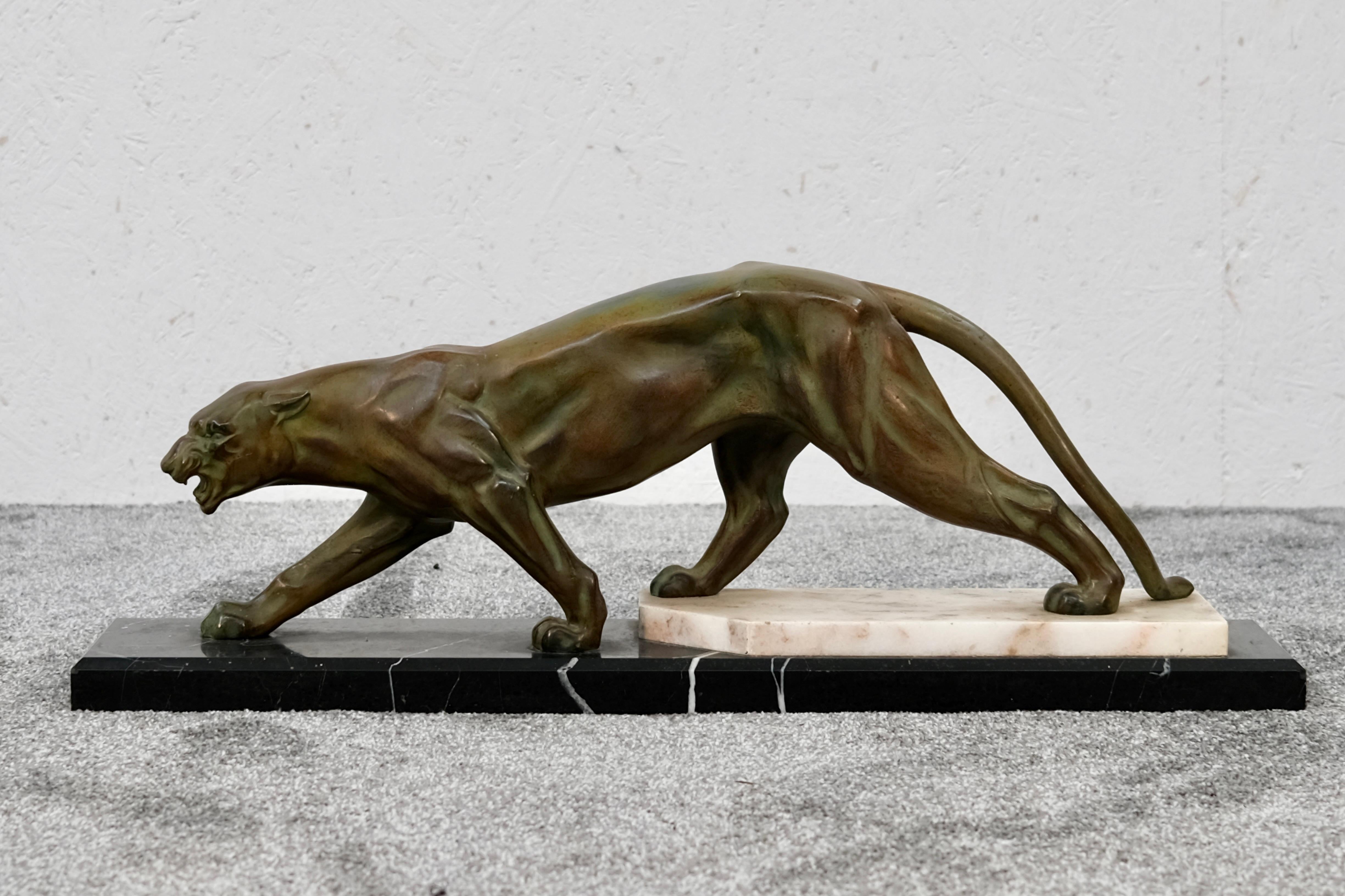 Powerful, elegant, and poised to pounce — this striking Art Deco panther sculpture captures the raw beauty and dynamism of the feline form. Crafted in France around 1930, the piece is cast in regule, a popular material of the period used to achieve
