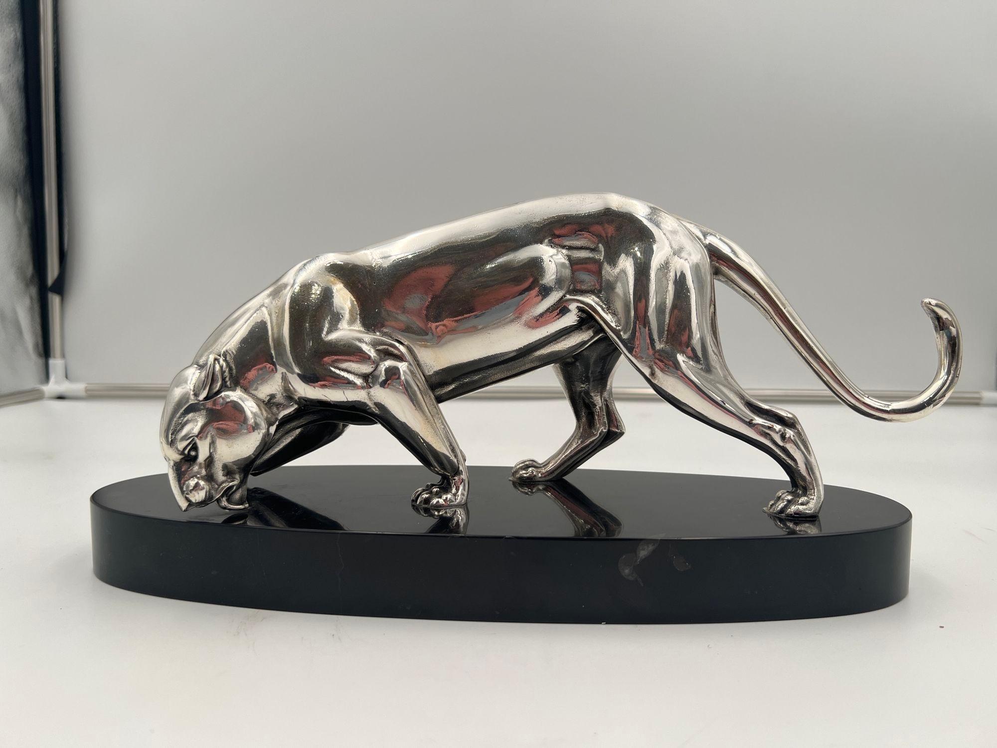 Beautiful small Art Deco panther sculpture from France around 1930.
Silver-plated cast pewter. Standing on an oval stone plinth.
Dimensions: H 17 cm x W 34.5 cm x D 11 cm