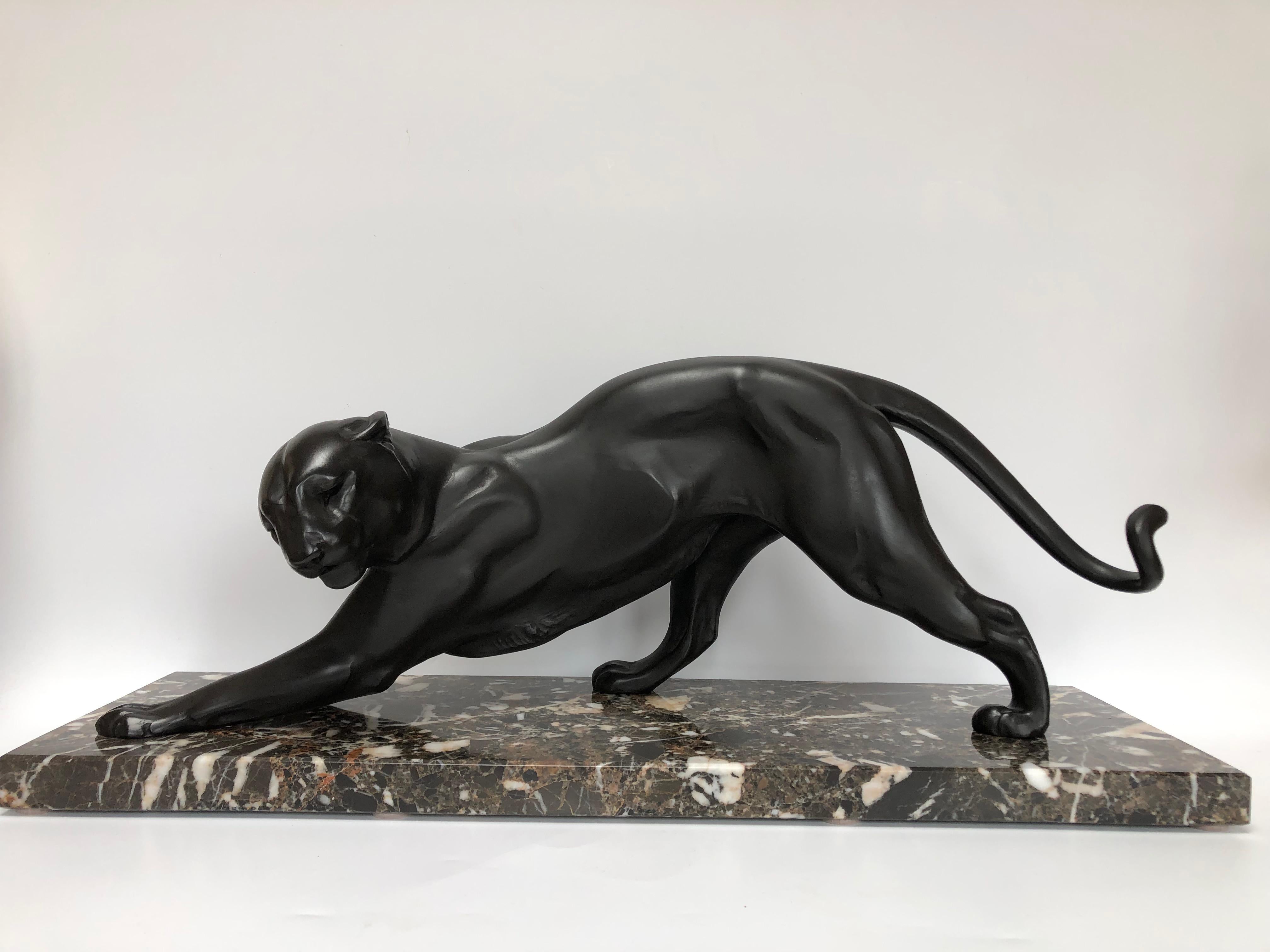 Panther around 1930 in black patina spelter on an oriental breccia marble base signed  