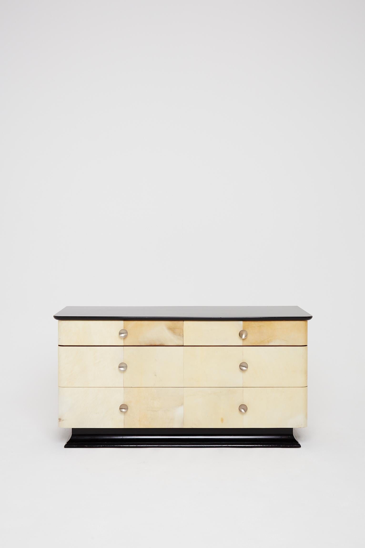 An Art Deco large velum and ebonized double chest of drawers.
France, circa 1940.