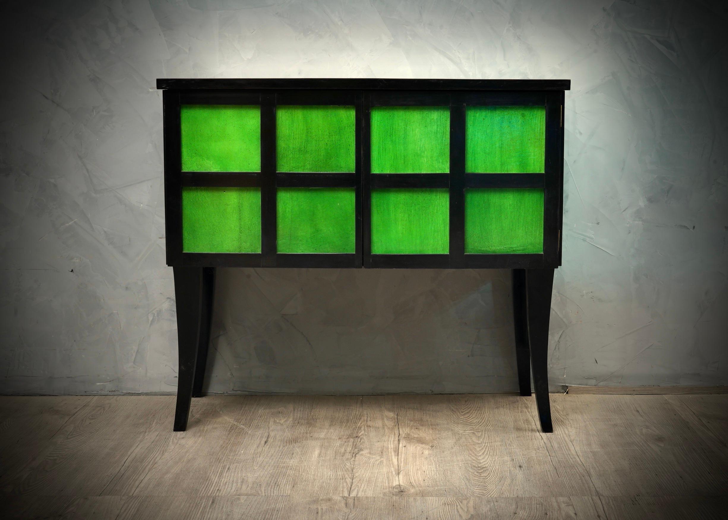 The small buffet sideboard is very particular, entirely polished with black shellac and covered in emerald green goatskin. A small piece of furniture but refined and classy; charismatic sideboard with a timeless design.

The sideboard has a black