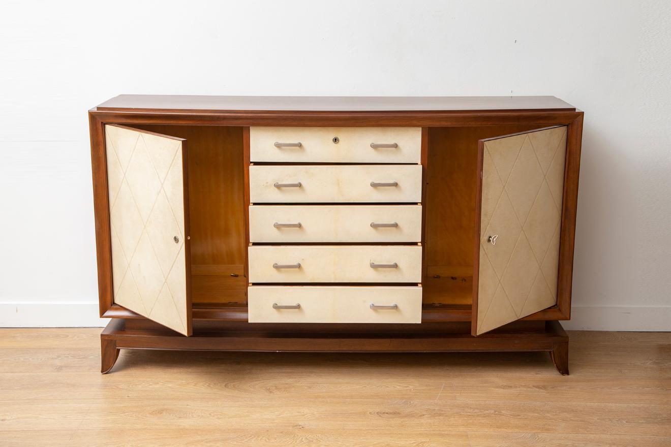 Art Deco parchment front cabinet by Jean Pascaud, France, 1935
Balanced upon four flared legs, 
Constructed of mahogany veneer 
Five drawers and two doors concelealing plenty of storage
Available to view in situ in our Miami gallery.