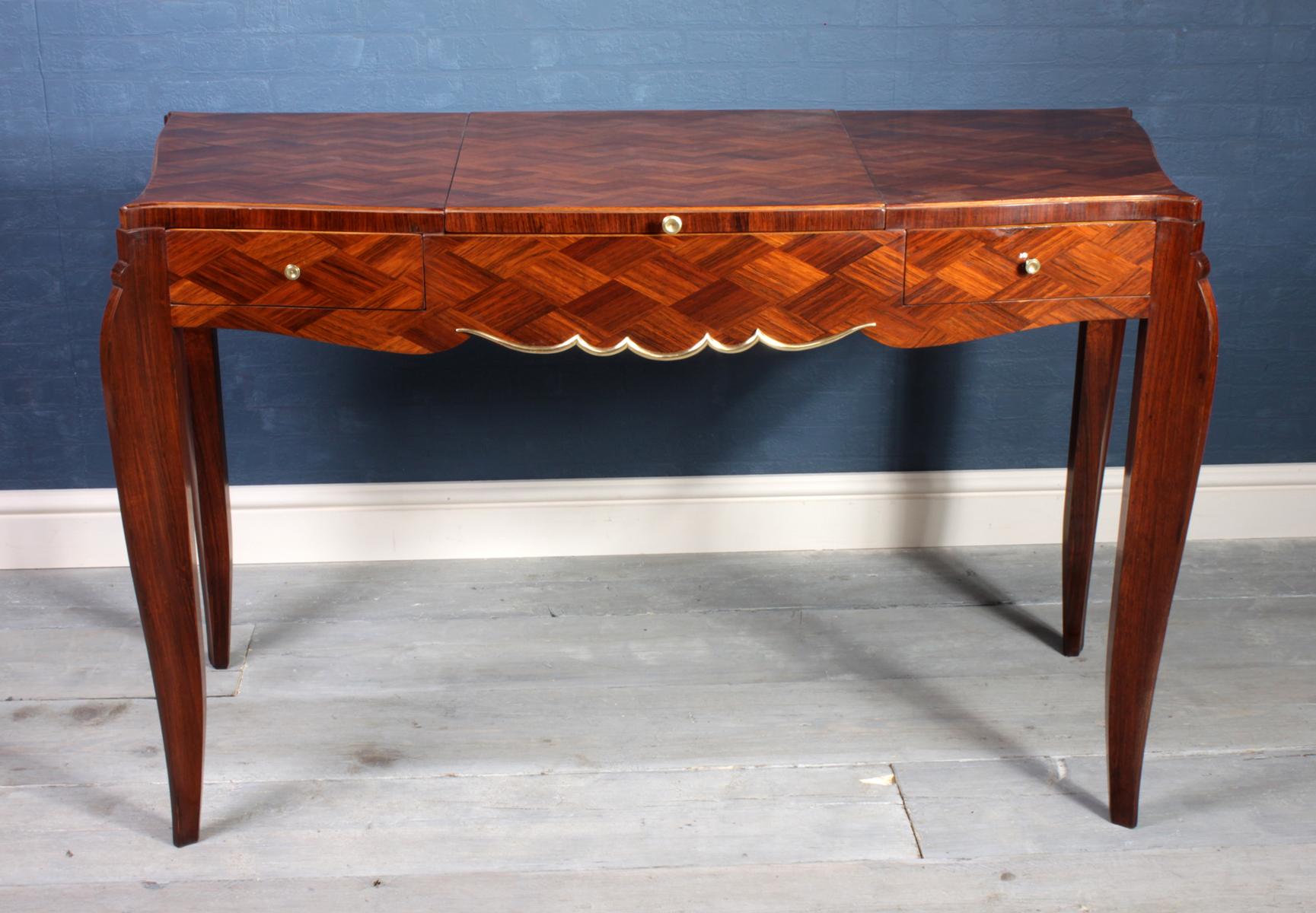 Art Deco parquetry dressing table, circa 1950
This fine quality serpentine shaped dressing table was produced in France in the mid 1950s in solid oak with palisander parquetry veneer with serpentine front and sides and elegant shaped legs, it has a